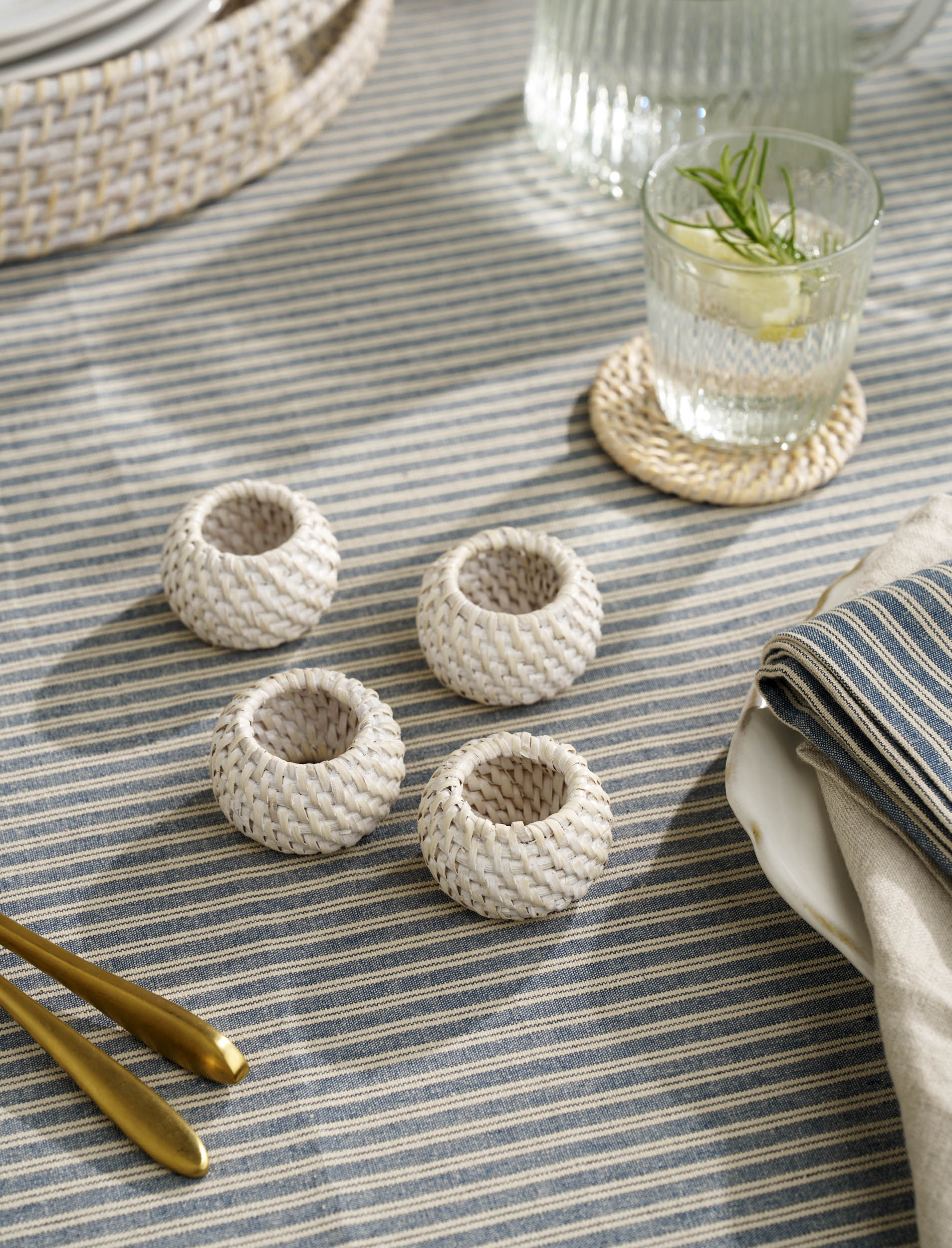 Set of four Wittering rattan white napkin rings by Sable Homeware, natural woven design for tableware decoration.