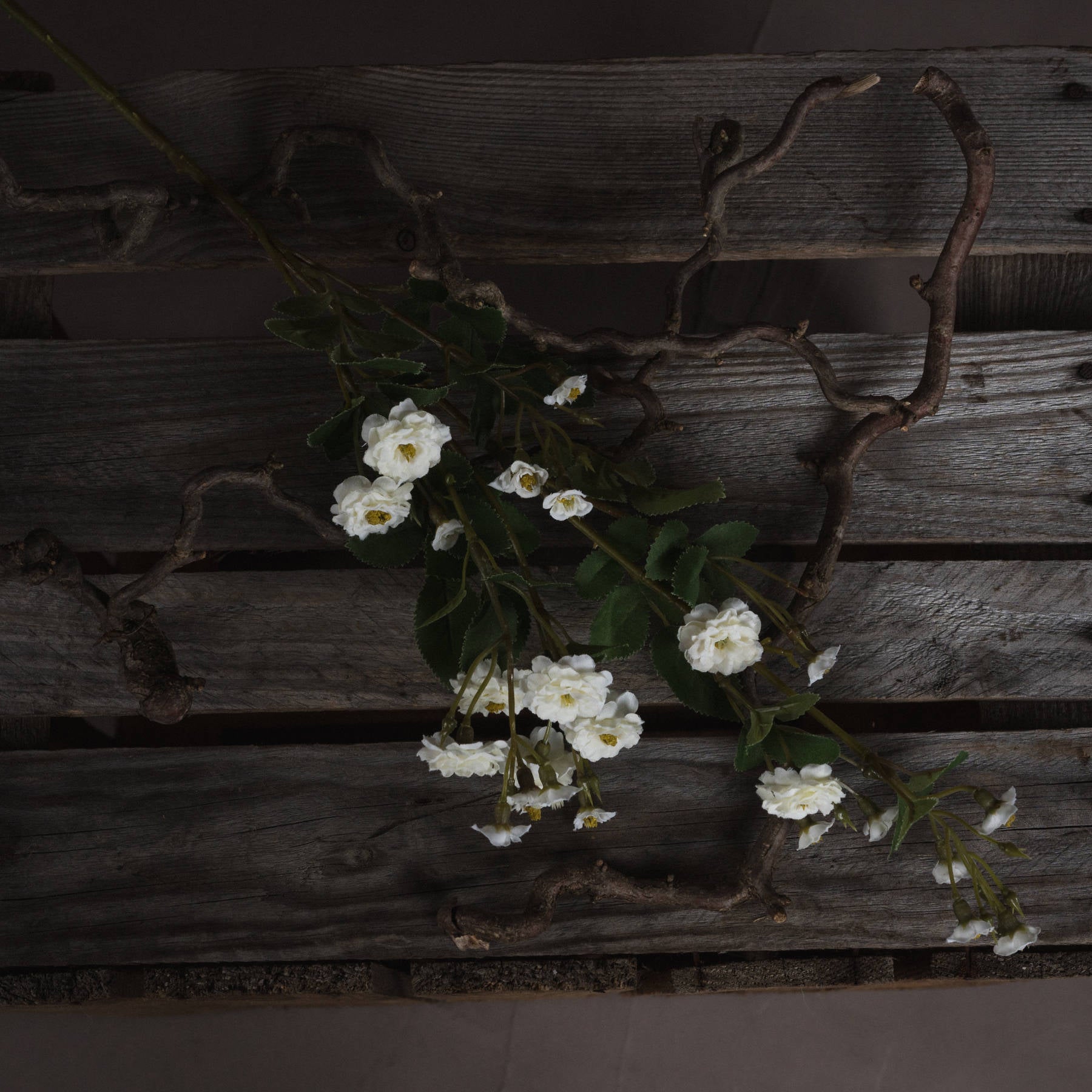 White Wild Meadow Rose faux flower branch from Sable Homeware with realistic wildflower blooms and green foliage.