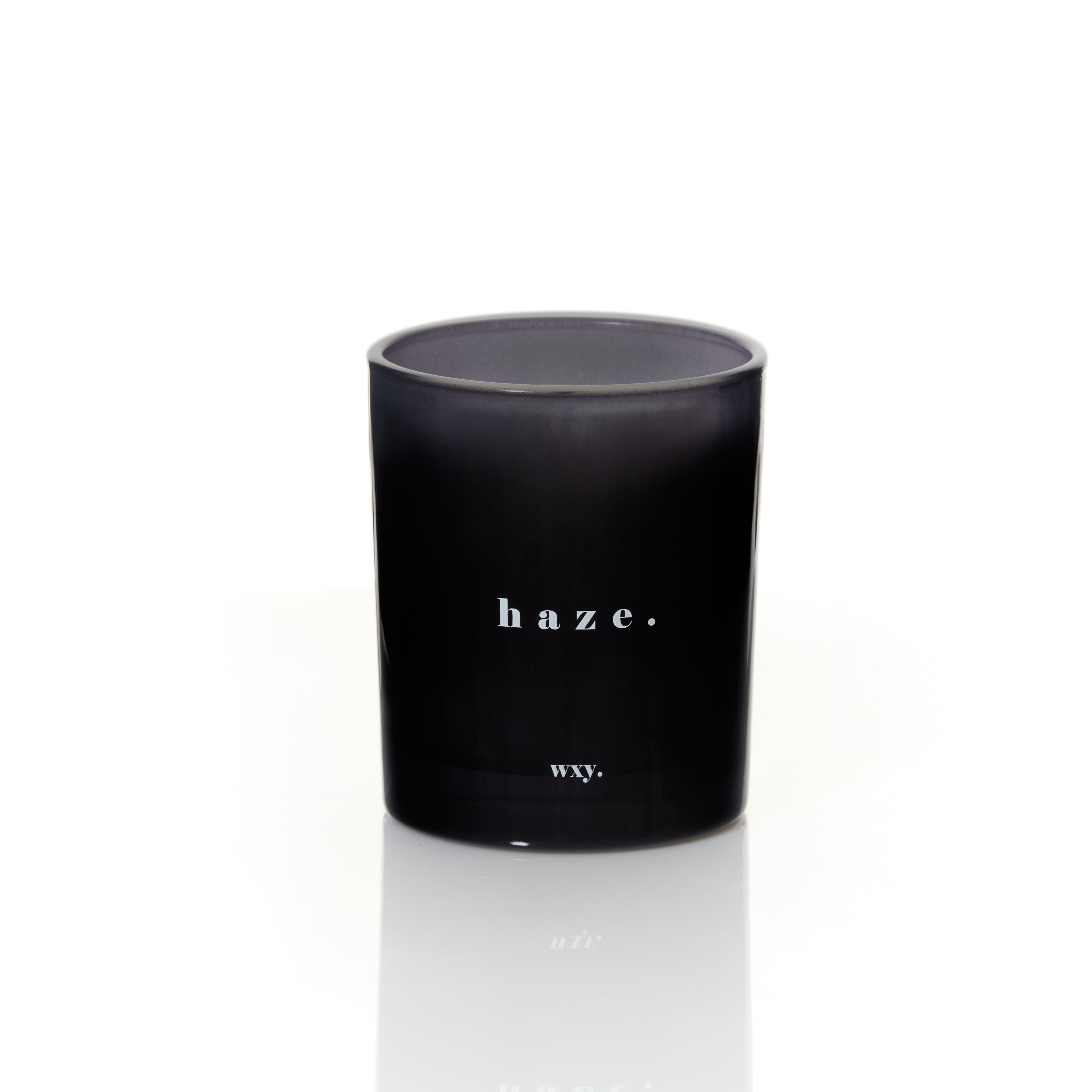 Haze Patchouli and Hemp scented candle by Sable Homeware, featuring a sleek glass container with a lit wick and aromatic wax.