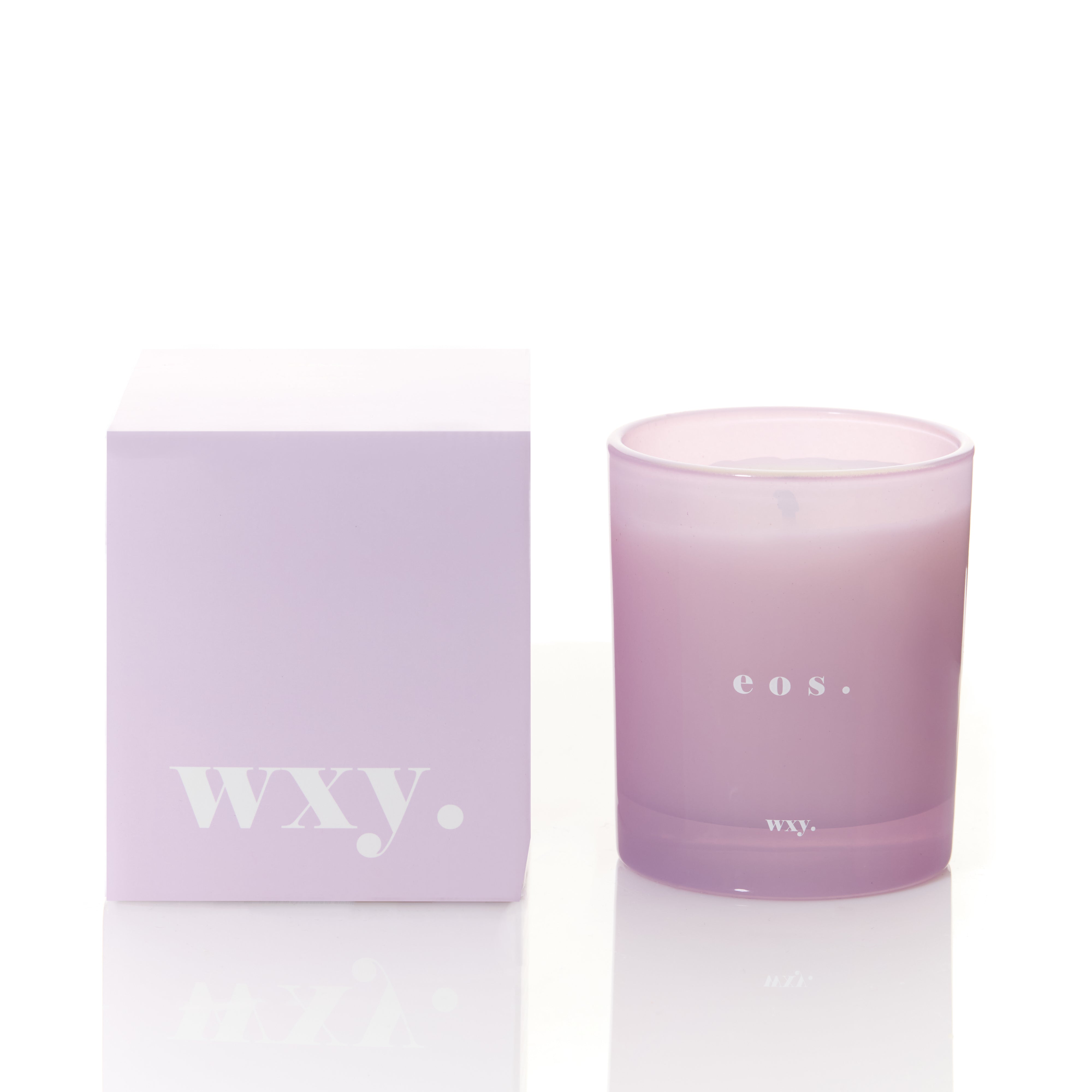 Sable Homeware Eos Orris Root and Amber scented candle in a glass holder with a lit wick, showcasing a warm, inviting glow.
