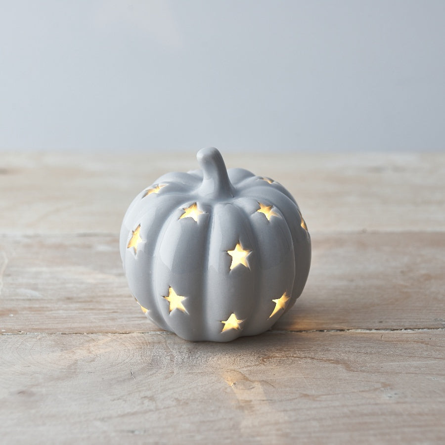 White LED ceramic pumpkin ornament by Sable Homeware, decorative fall or Halloween decor with a soft glowing light.