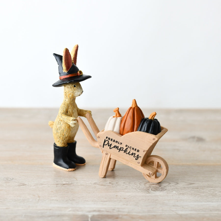 Shabbyquins Halloween rabbit ornament holding a wheelbarrow with pumpkin decorations, crafted in a charming, rustic style.