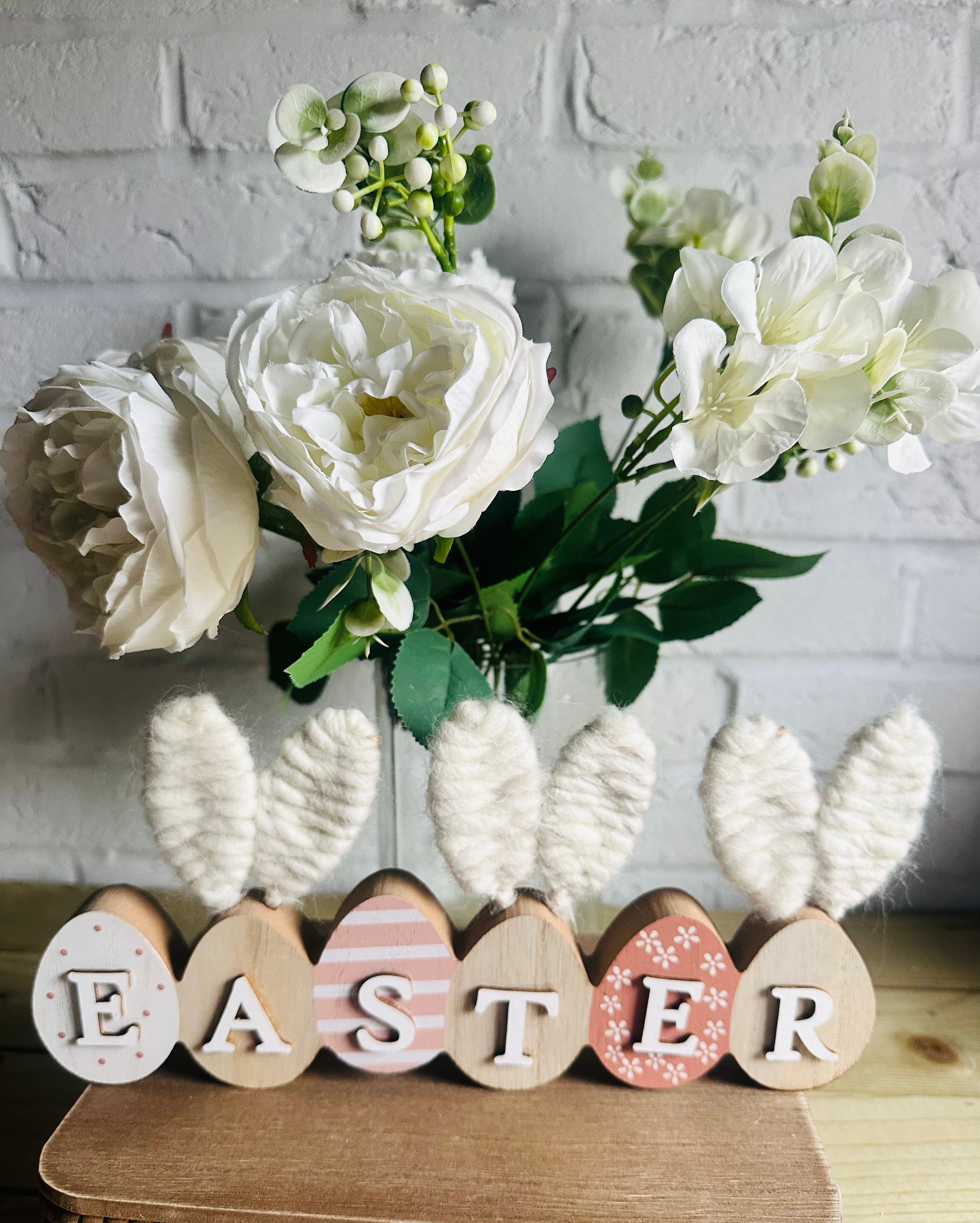 Faux white roses and greenery foliage spray with realistic leaves, perfect for floral arrangements or home decor.