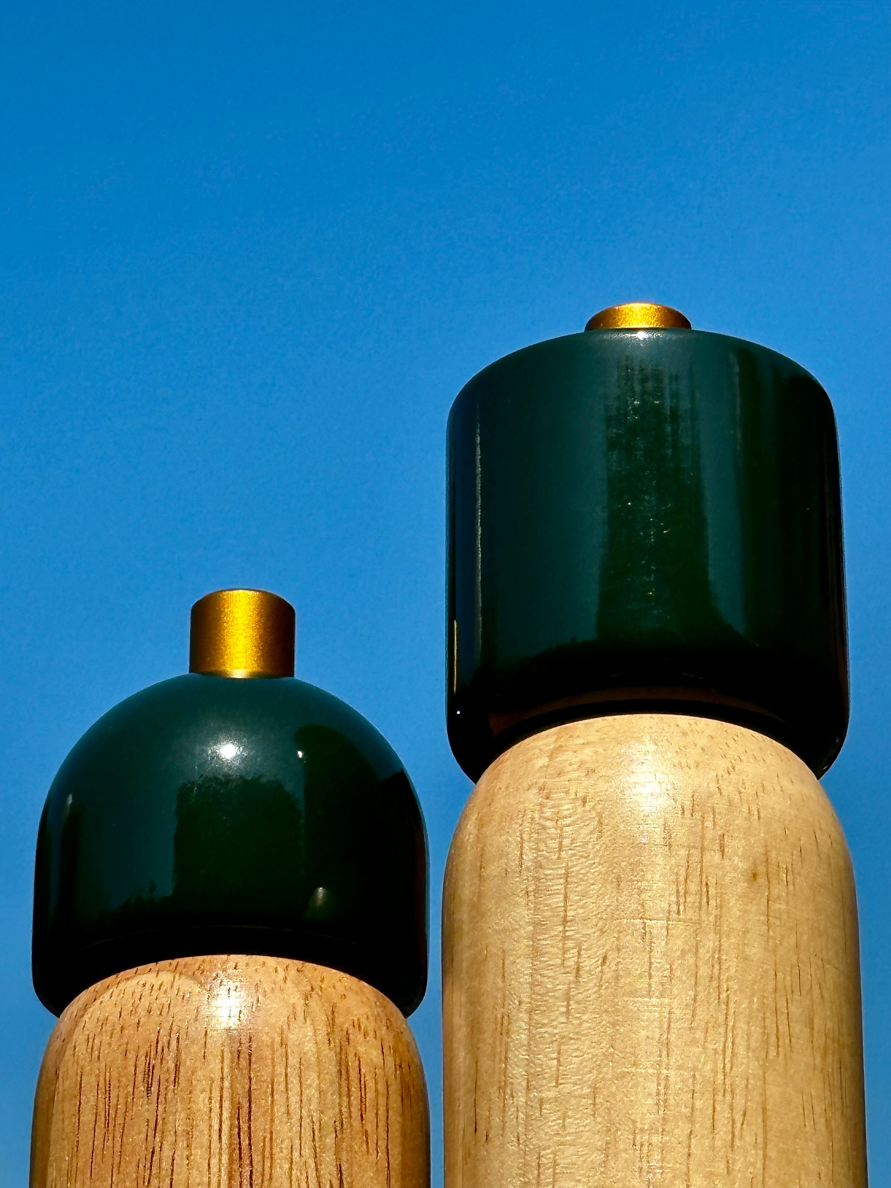 Sable Homeware Deluxe salt and pepper grinders in green and gold with sleek, modern design for table seasoning.