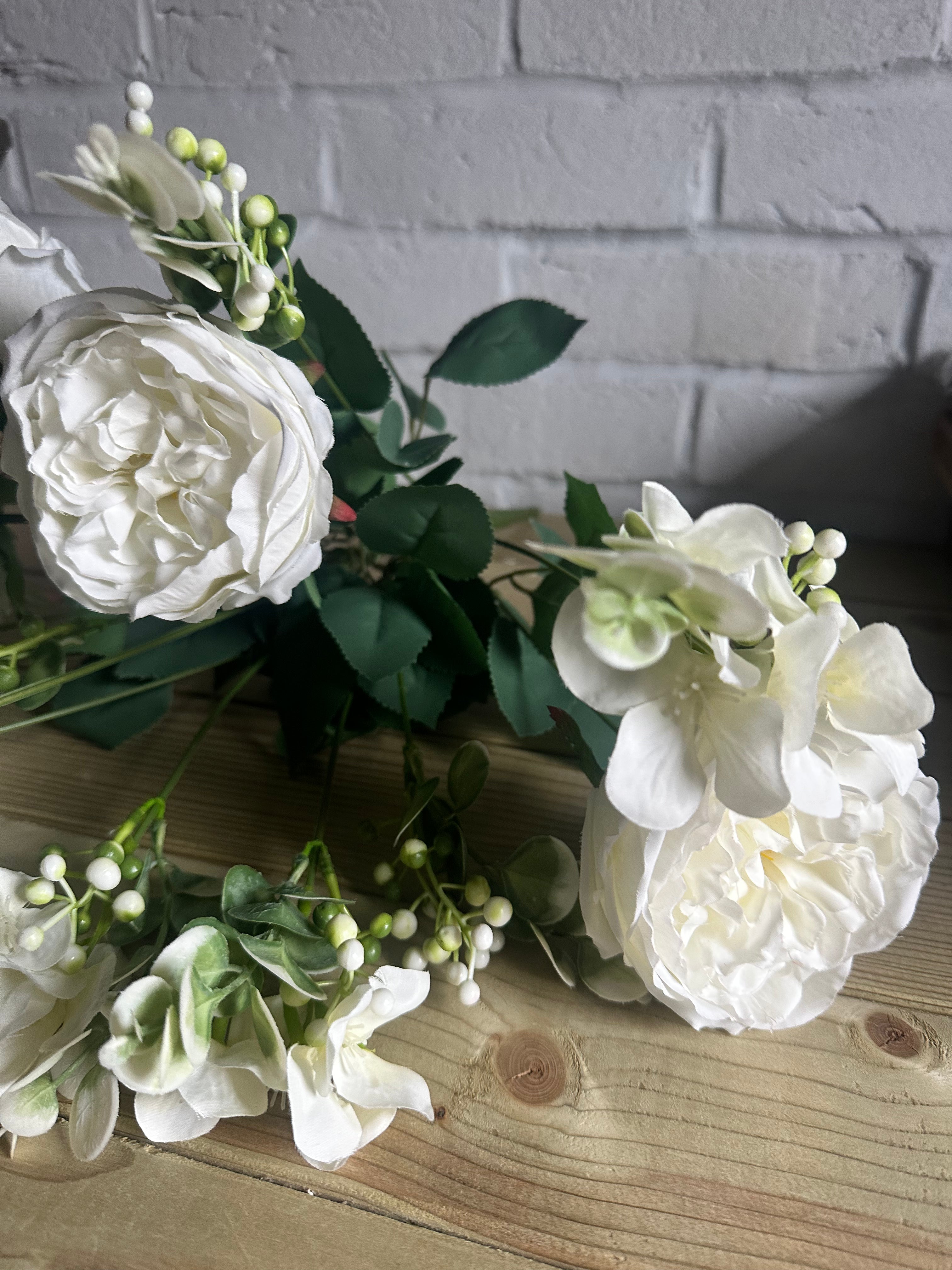 Faux white roses and foliage spray by Sable Homeware with green leaves and delicate white blooms