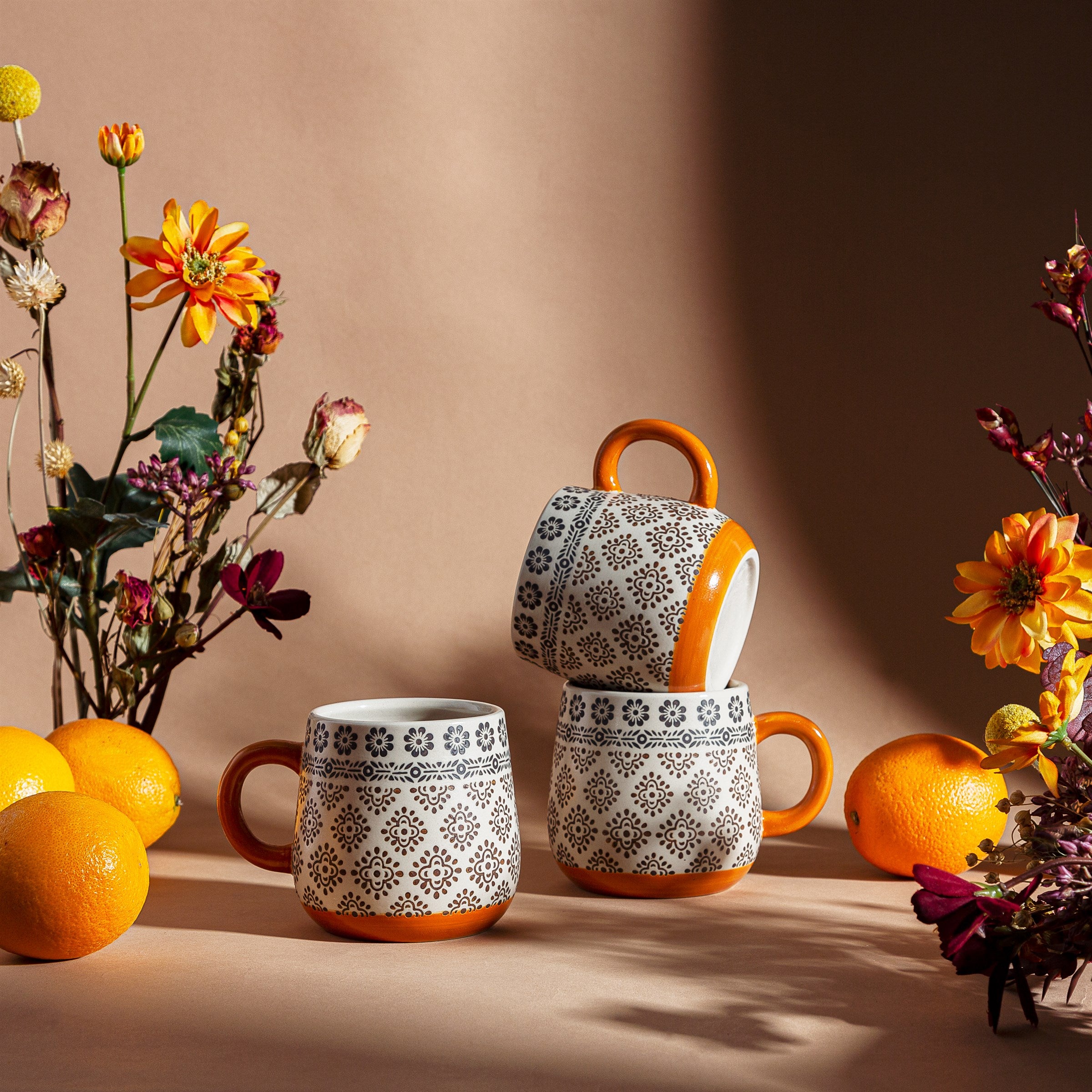 Anika Geometric Mug by Sable Homeware featuring a modern geometric pattern, shown in a lifestyle setting on a table.