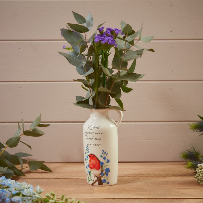 White vase with a robin design by Shabbyquins, featuring a charming bird motif, ideal for displaying flowers or decorative arrangements.