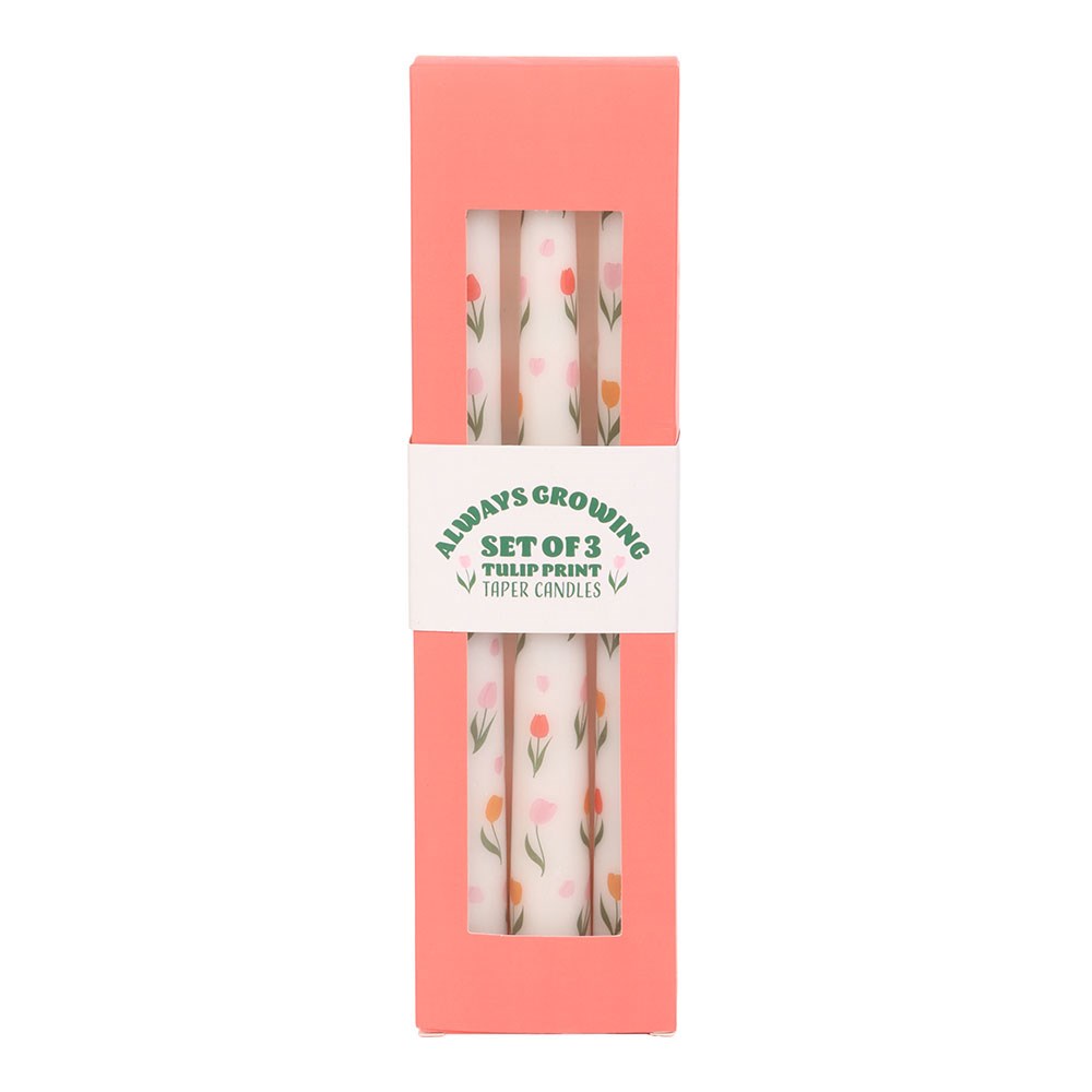 Set of three Sable Homeware tulip print taper candles with colorful tulip designs on white wax.