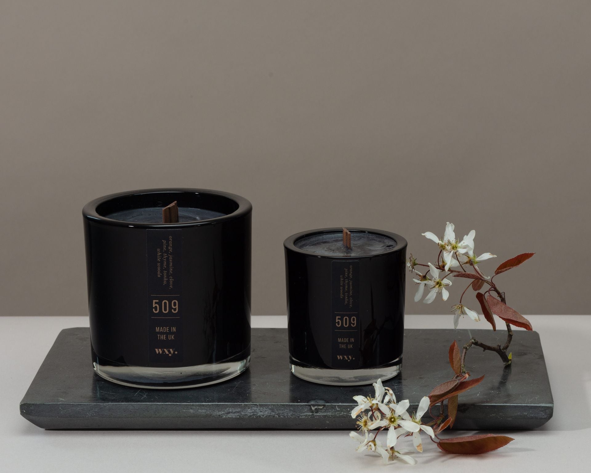 Sable Homeware Wxy Luxury Umbra Candle and Room Spray in orchid rose, jasmine, and clove, displayed in a stylish candle holder.