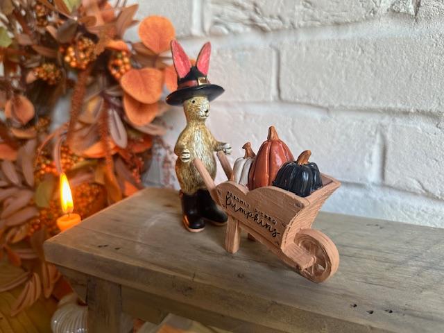 Shabbyquins Halloween rabbit ornament holding a wheelbarrow filled with pumpkins, decorative outdoor garden ornament.
