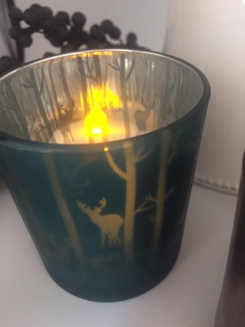 Sable Homeware Woodland Christmas tealight holder featuring a festive forest design with candles inside.
