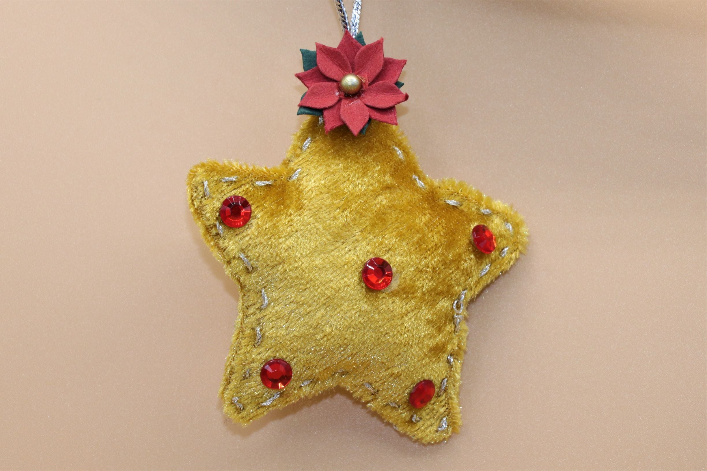 Handmade Sable Homeware Christmas Tree Ornaments featuring festive designs hanging on a decorated Christmas tree.
