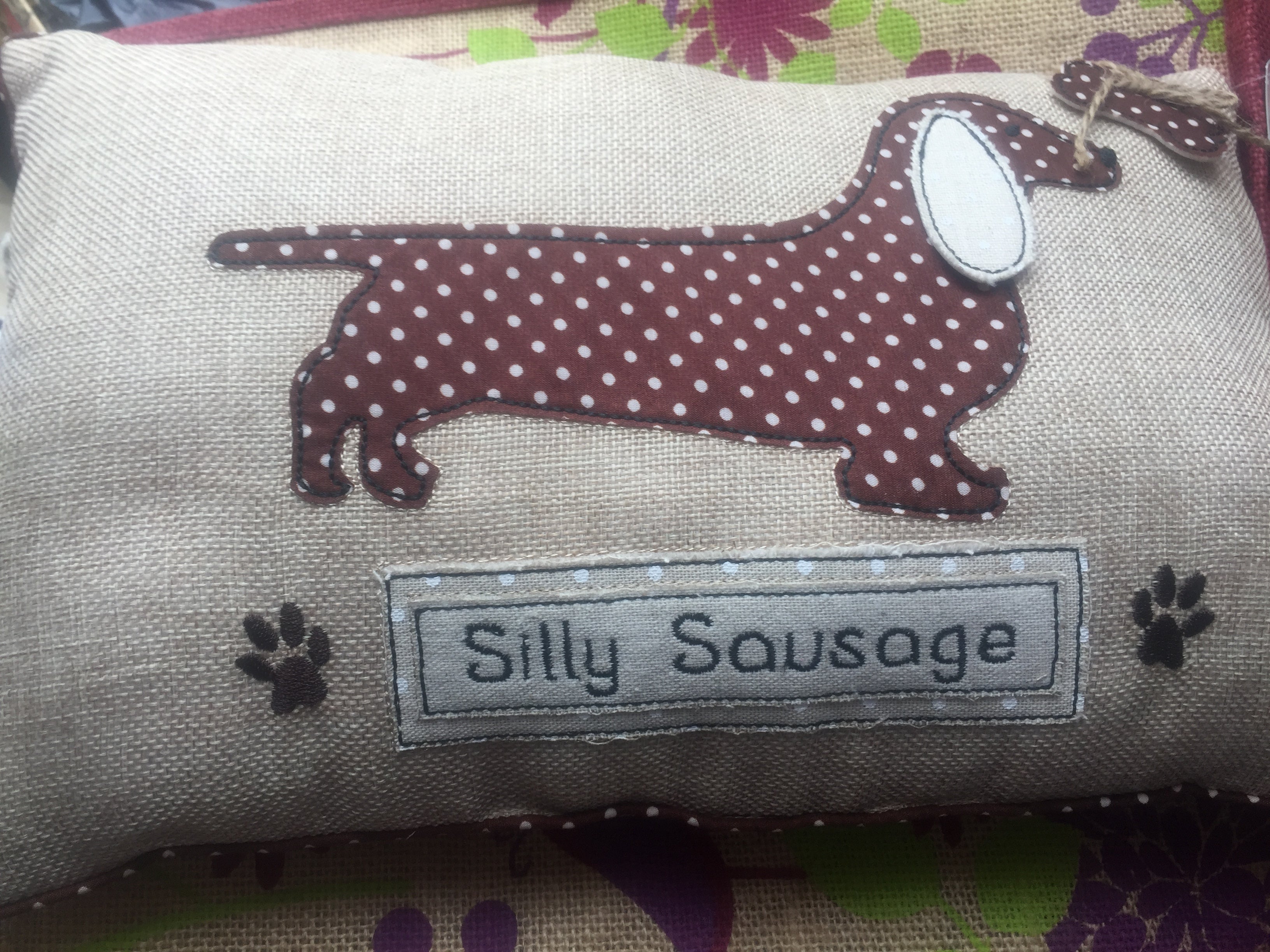 Shabbyquins Silly Sausage Oblong Cushion with playful sausage design and soft fabric, perfect for cozy home decor.
