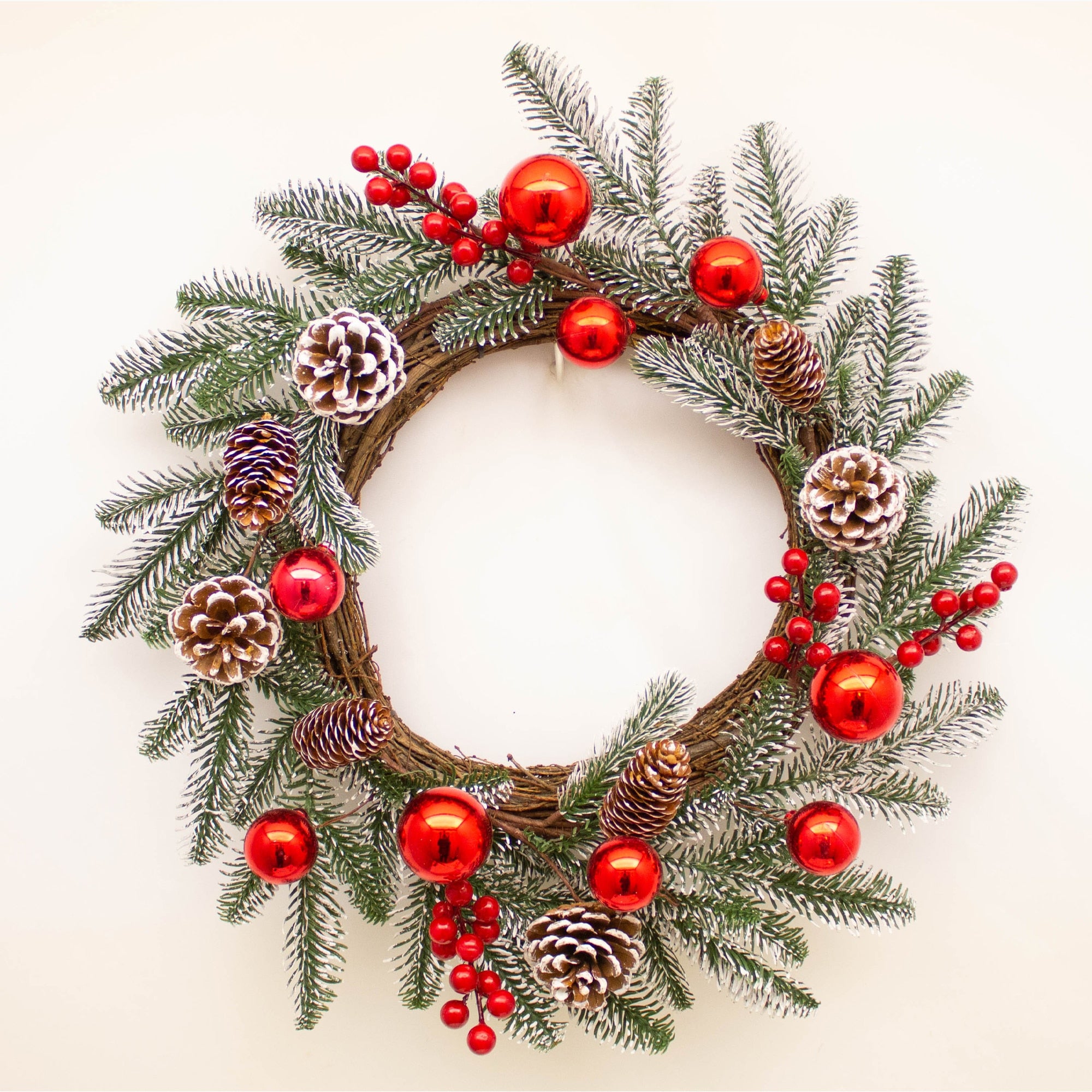 Large frosted wreath with pinecones and red baubles, perfect for holiday decor, by Shabbyquins.