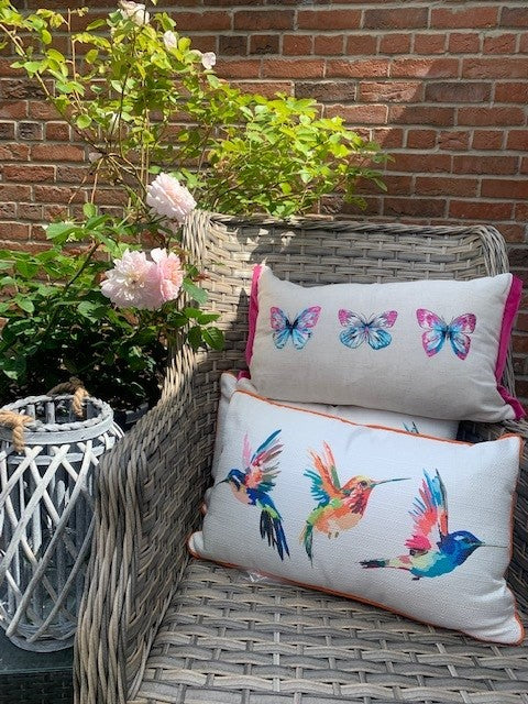 Rectangular cushion with hummingbird and butterfly designs by Shabbyquins, featuring vibrant nature-inspired patterns.