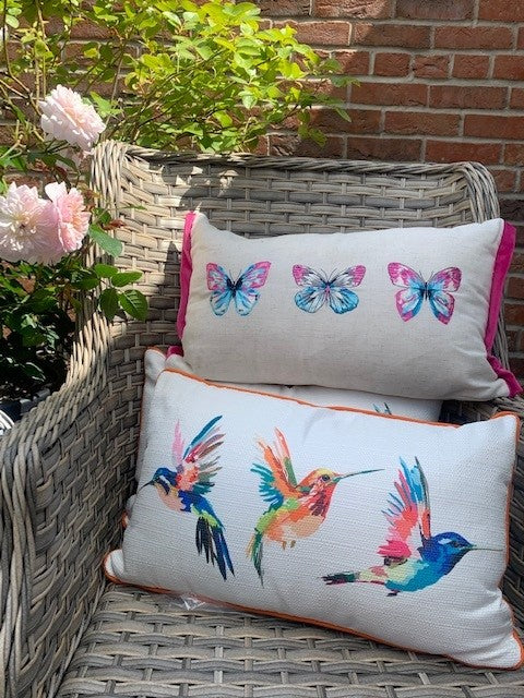 Rectangular cushion with hummingbird and butterfly designs by Shabbyquins, featuring colorful nature-inspired embroidery on soft fabric.