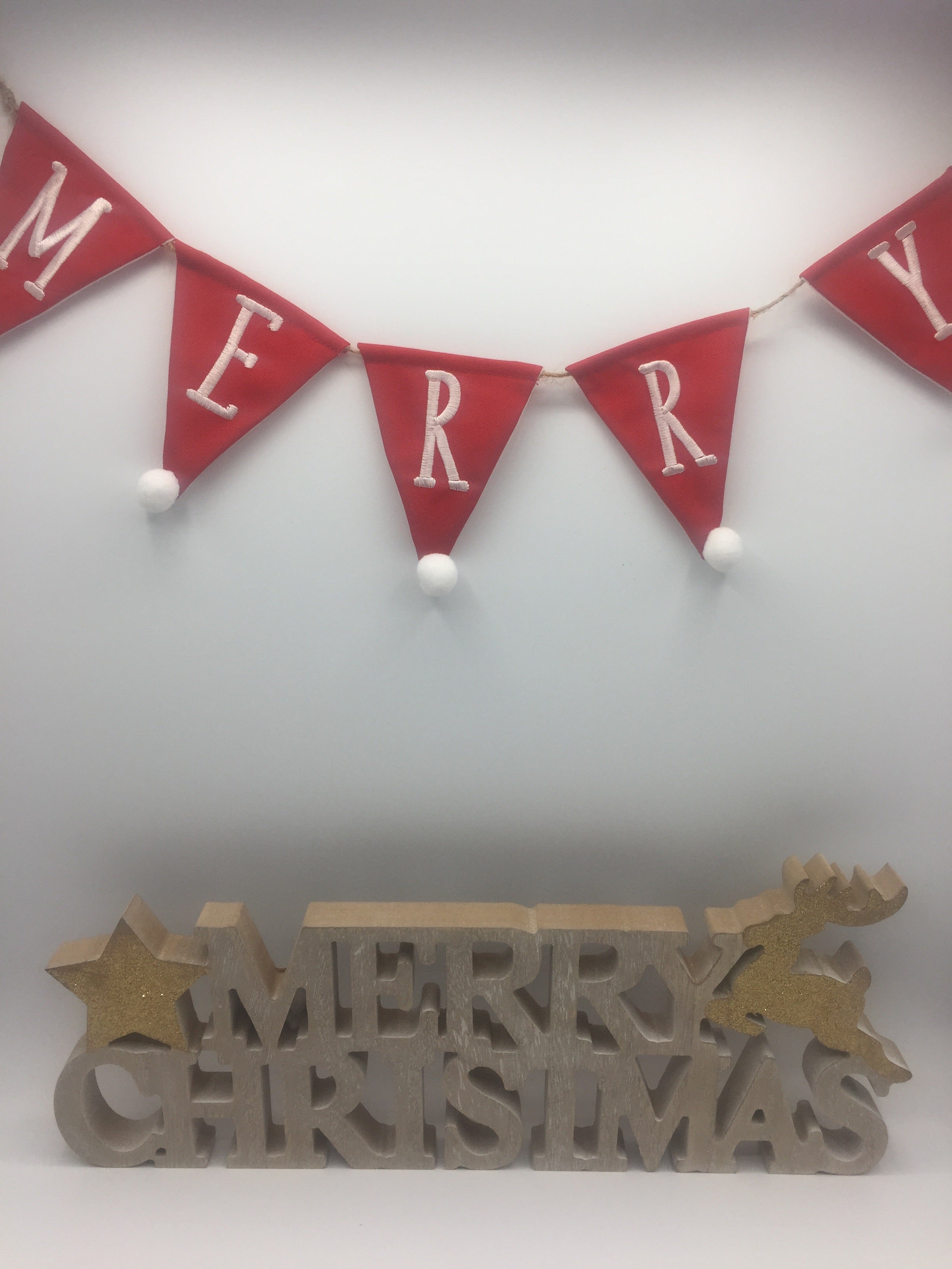 Red Merry Christmas bunting garland by Shabbyquins with festive flags and holiday-themed lettering, perfect for Christmas decorations.