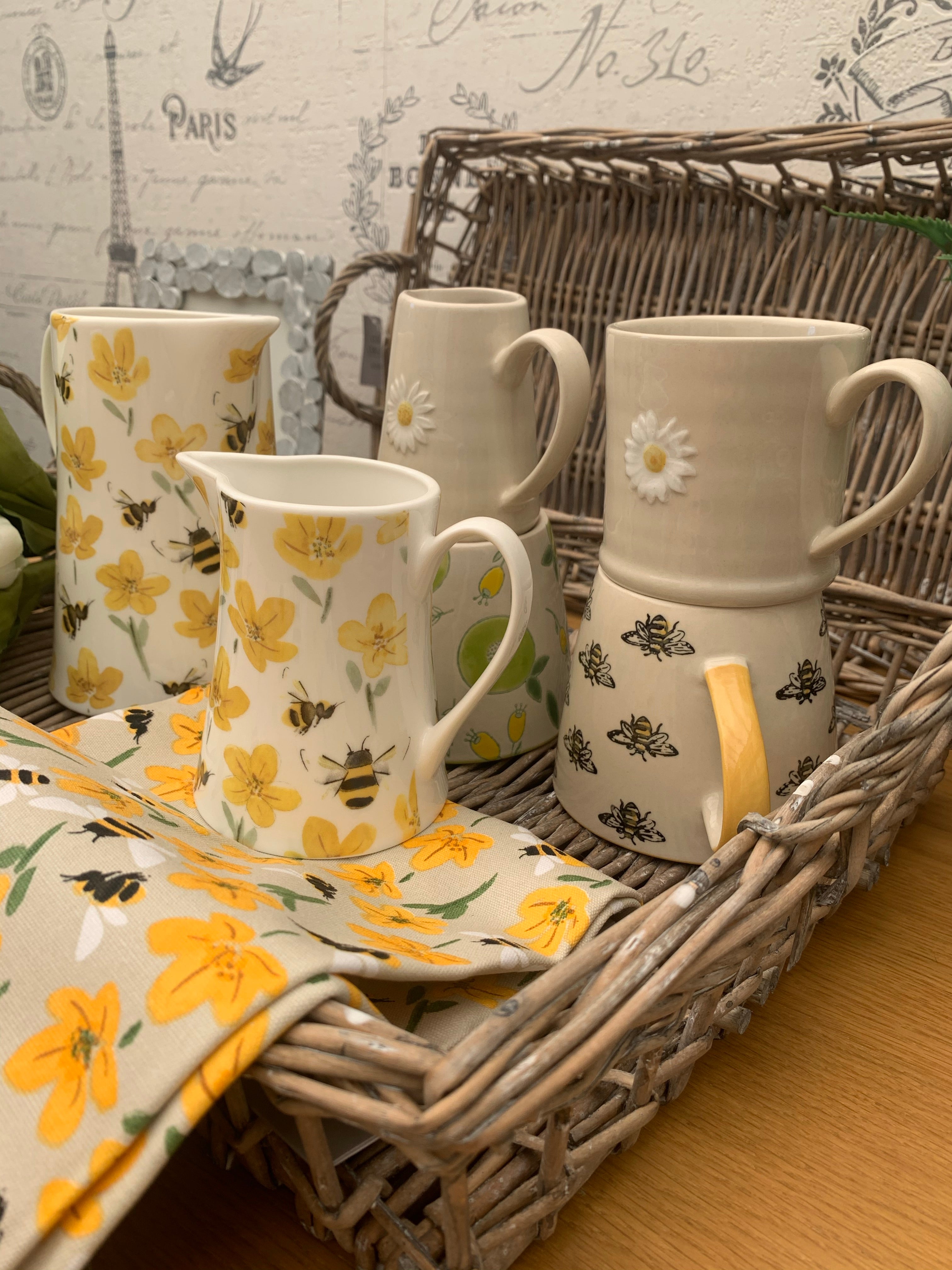 Bees and buttercups tea towel with floral and insect pattern from Sable Homeware, perfect for kitchen decor.