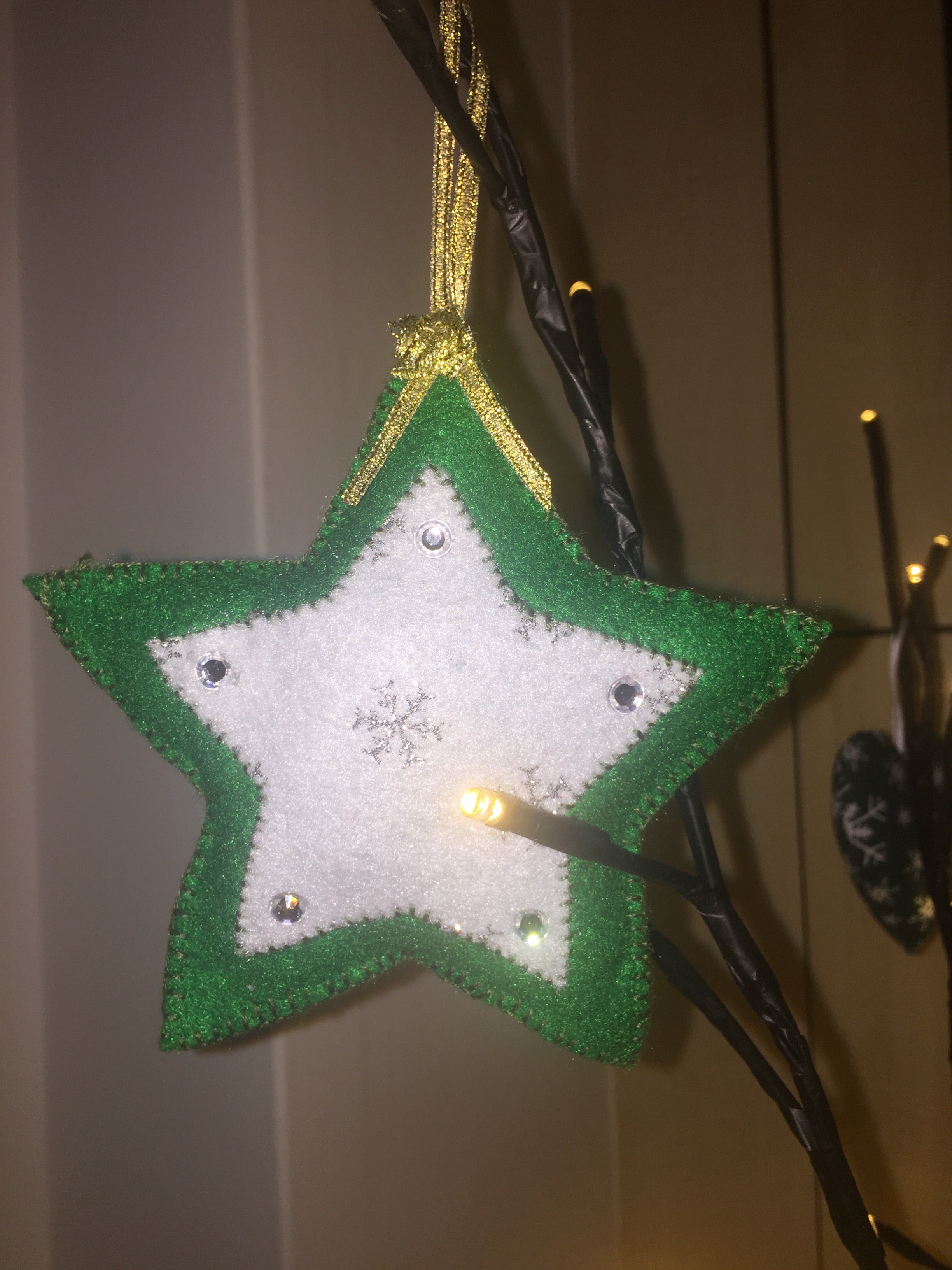 Handmade Christmas Tree Ornaments from Sable Homeware, featuring festive holiday decorations hanging on a Christmas tree.