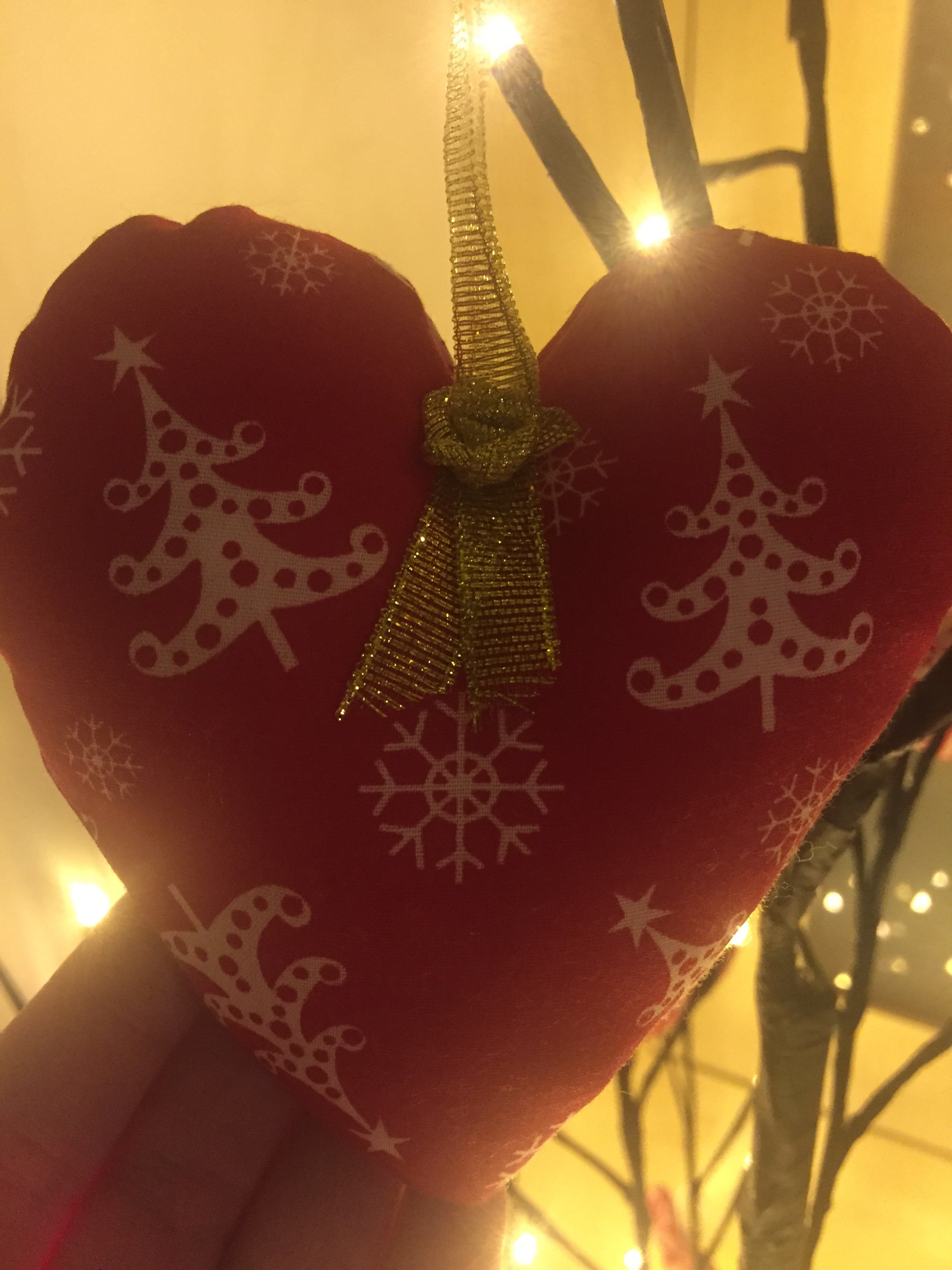 Handmade Sable Homeware Christmas Tree Ornaments hanging on a decorated tree with festive lights and greenery.
