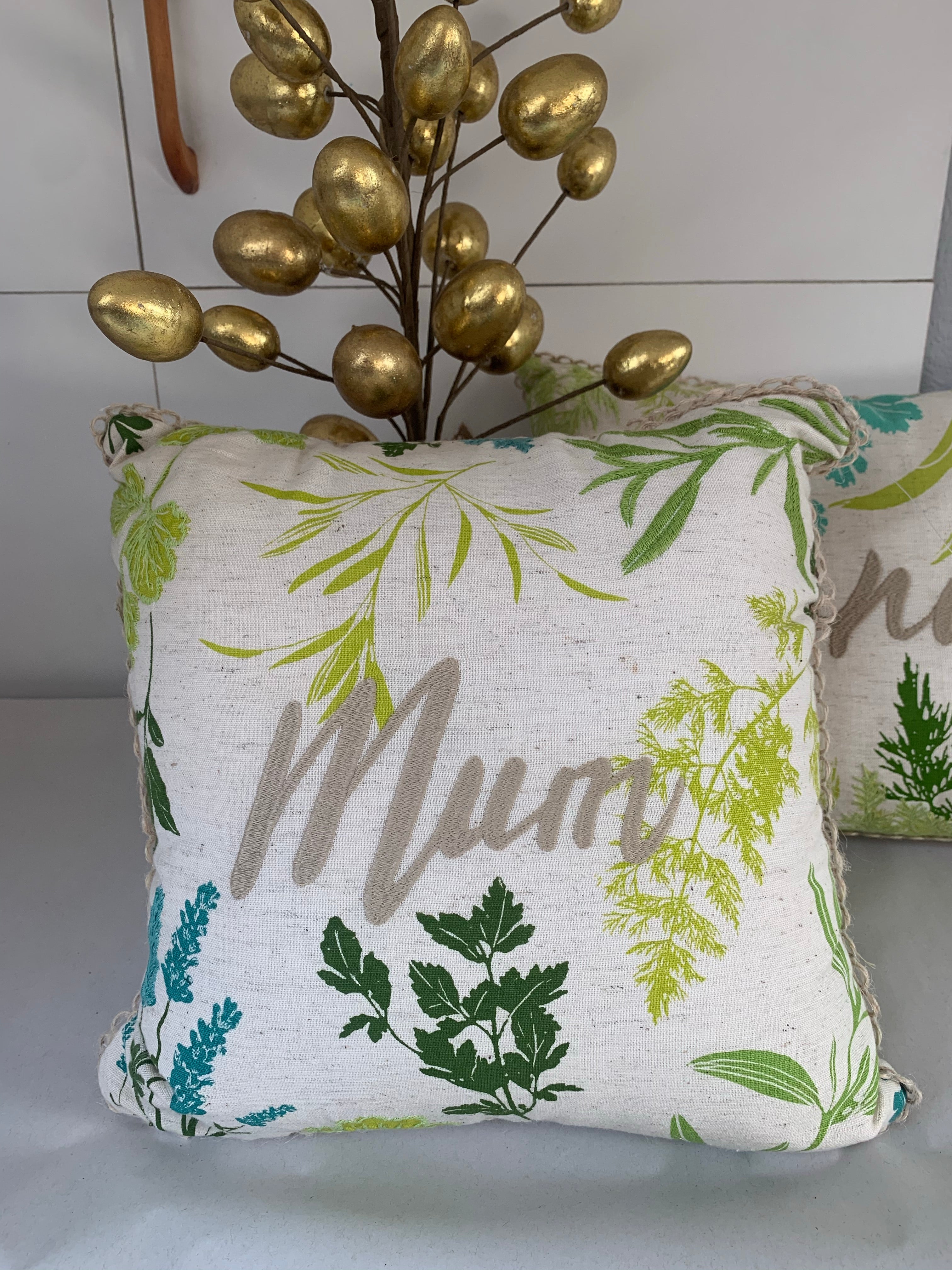 Green and blue floral cushions by Shabbyquins, featuring Mum and Grandma designs, with vibrant floral fabric and cozy padding.