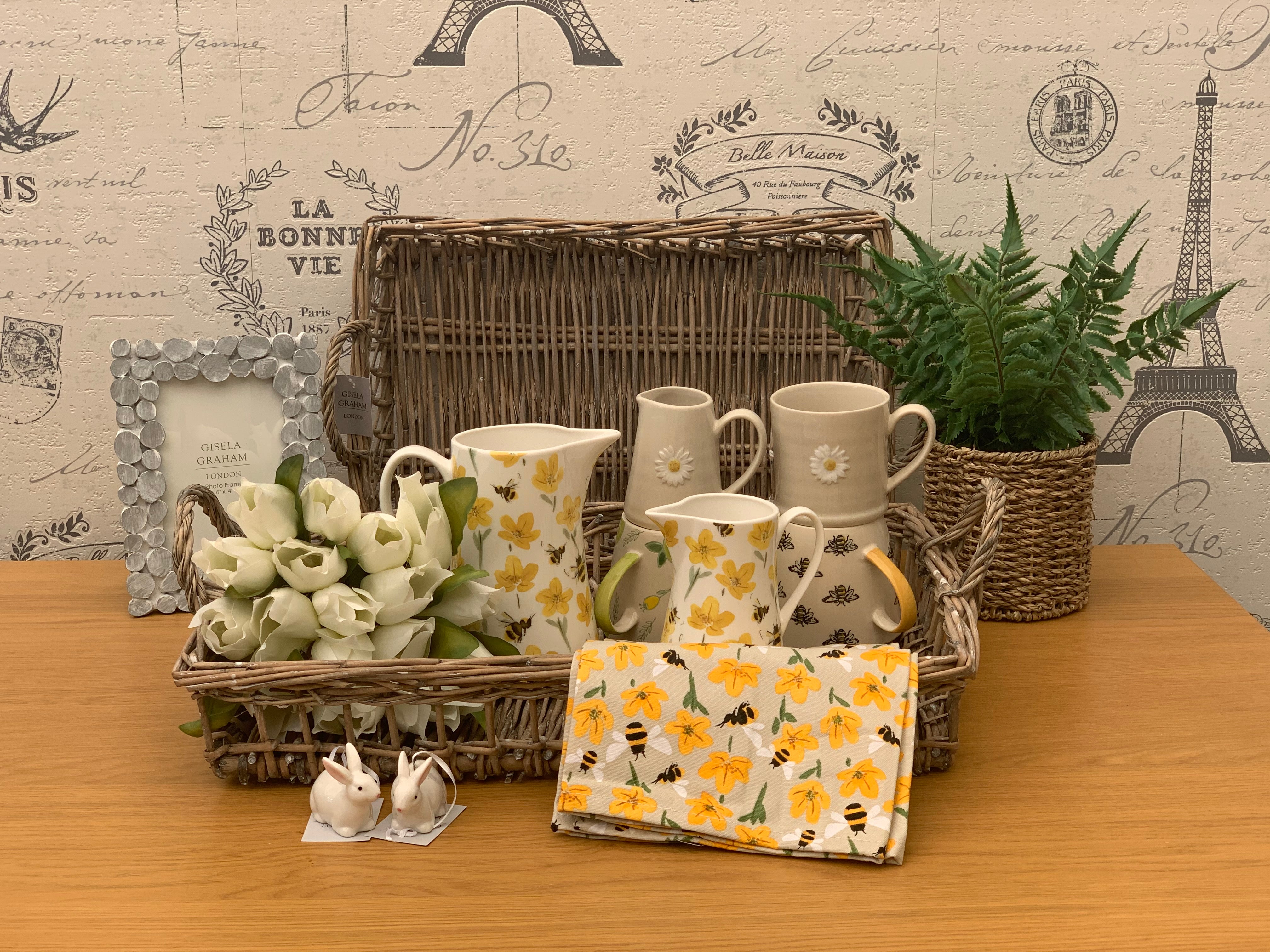 Bees and buttercups tea towel from Sable Homeware, featuring floral and bee patterns, displayed on a kitchen surface.