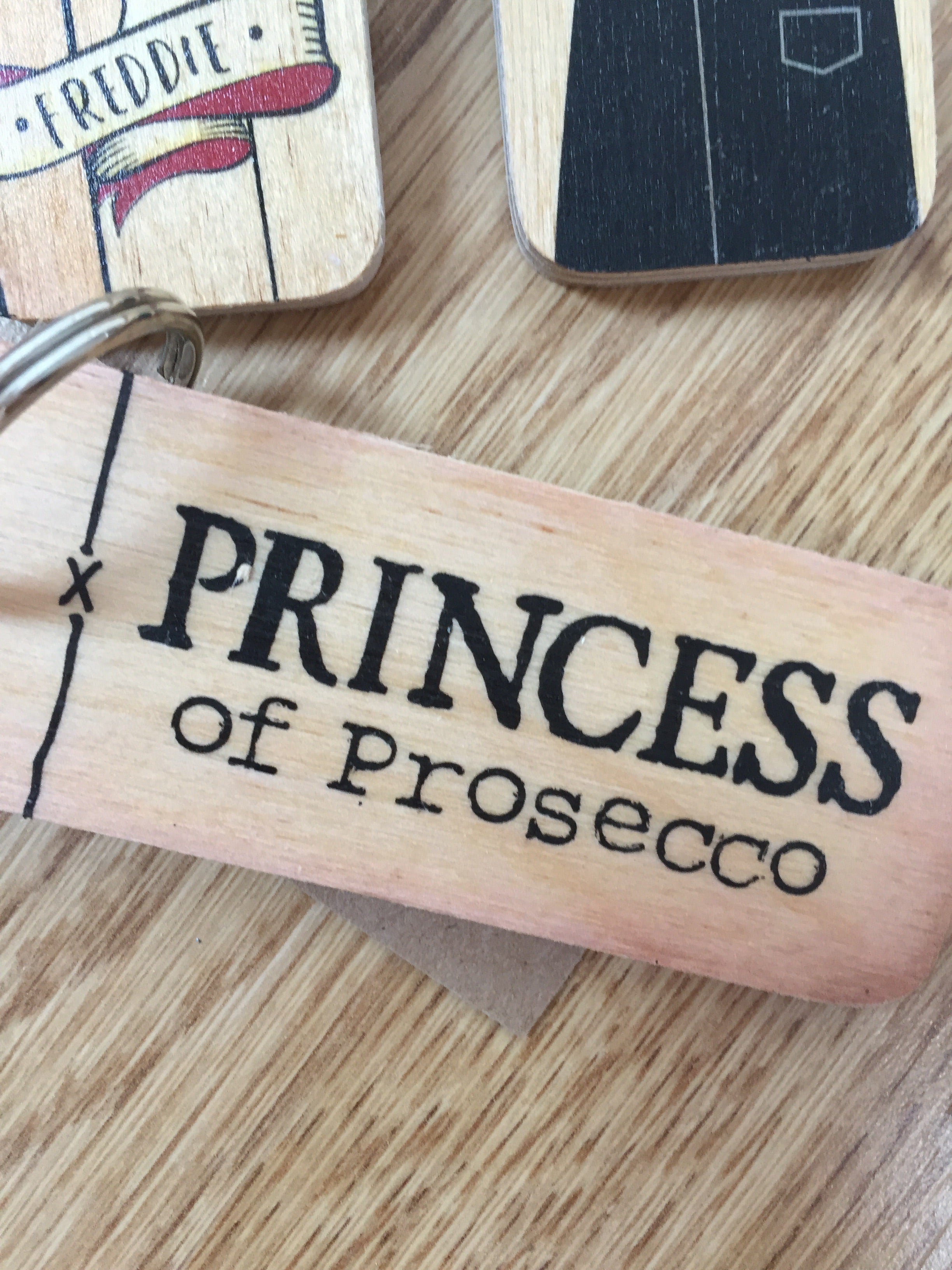 Handmade chunky wooden keyring from Sable Homeware with a smooth finish and natural wood grain, attached to a metal keyring.