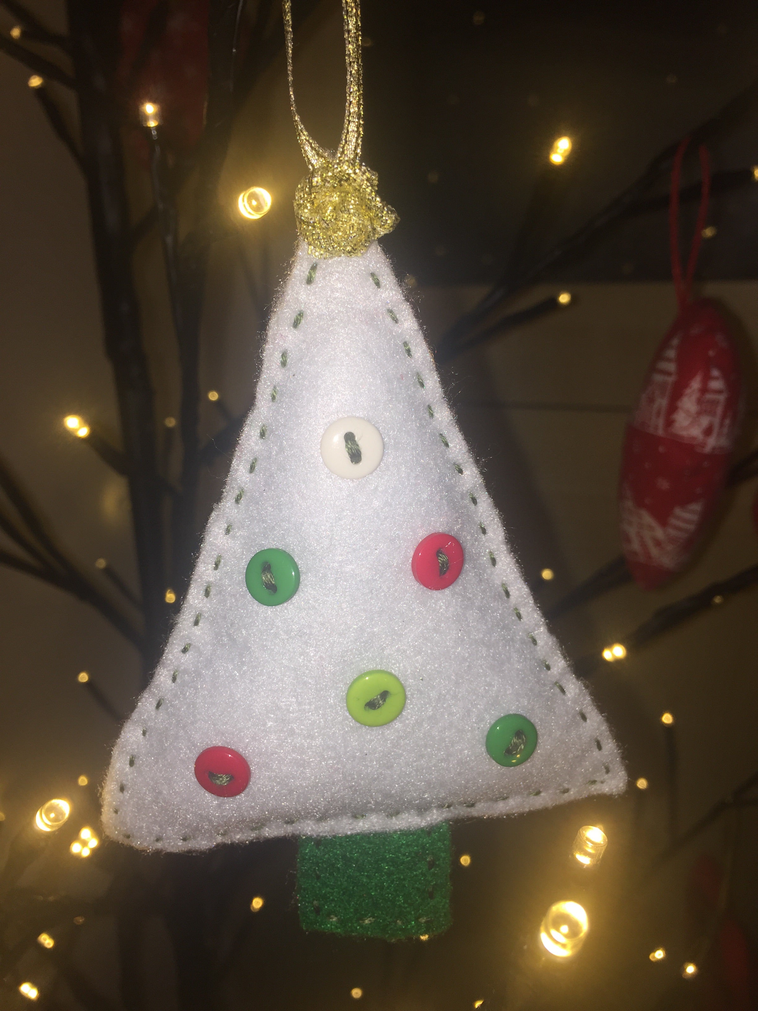 Handmade Christmas Tree Ornaments by Sable Homeware, featuring colorful festive decorations hanging on a Christmas tree.