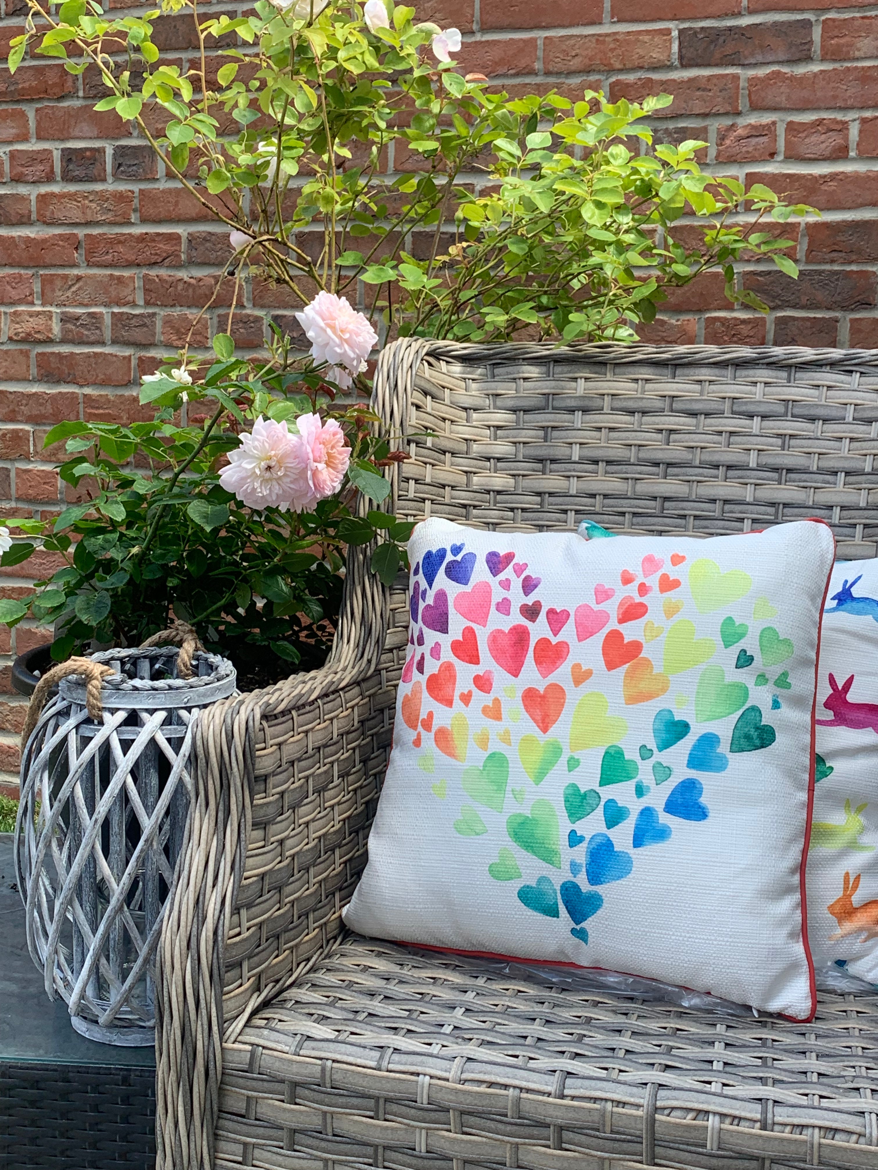 Colorful Rainbow Brights Cushion by Shabbyquins featuring vibrant rainbow patterns and soft fabric for cozy decor.