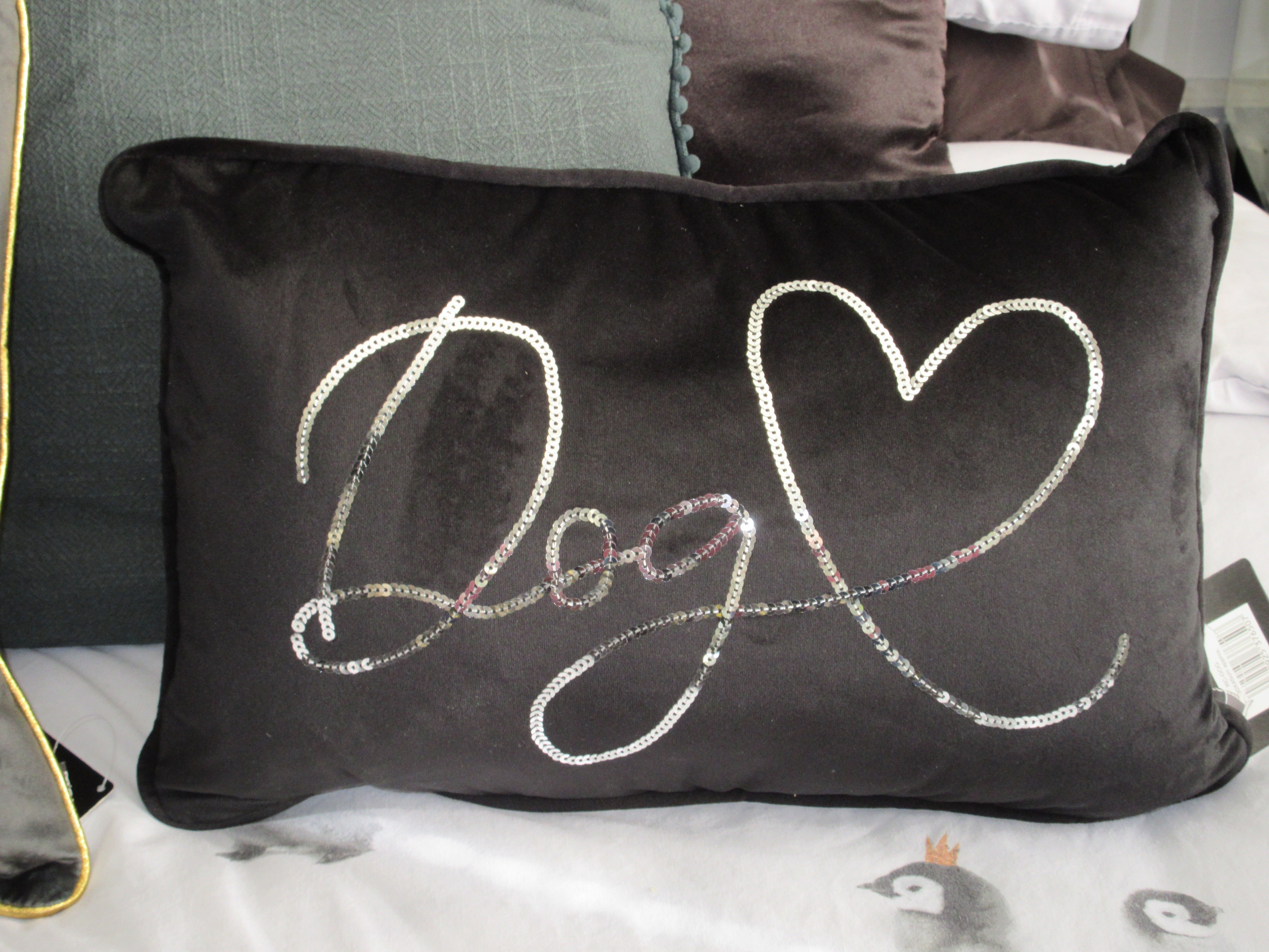Black velvet sequin cushion featuring a cute cat or dog design from Sable Homeware, perfect for cozy home decor.