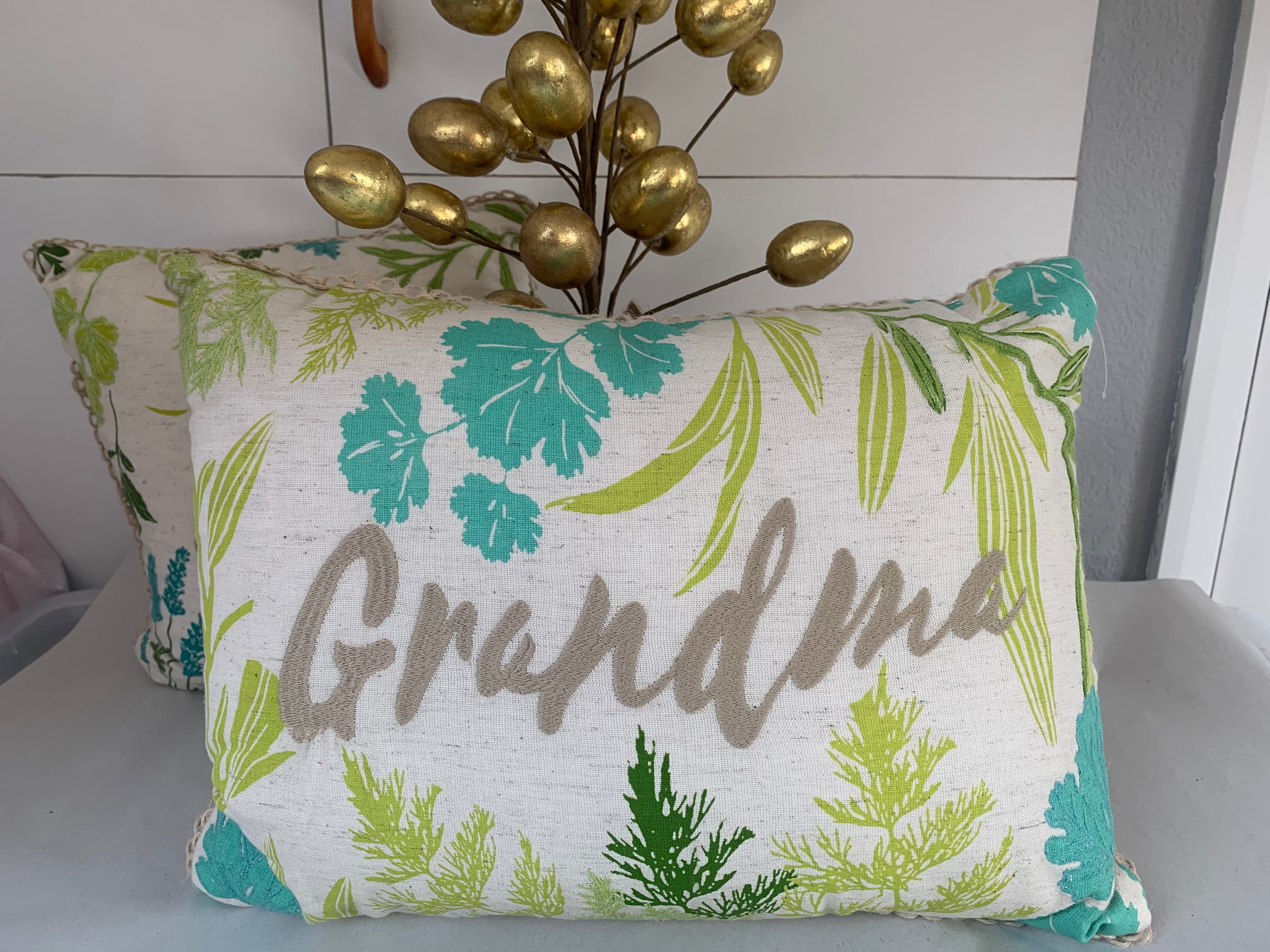Green and blue floral cushions by Shabbyquins, featuring Mum and Grandma designs, with vibrant fabric and decorative floral patterns.