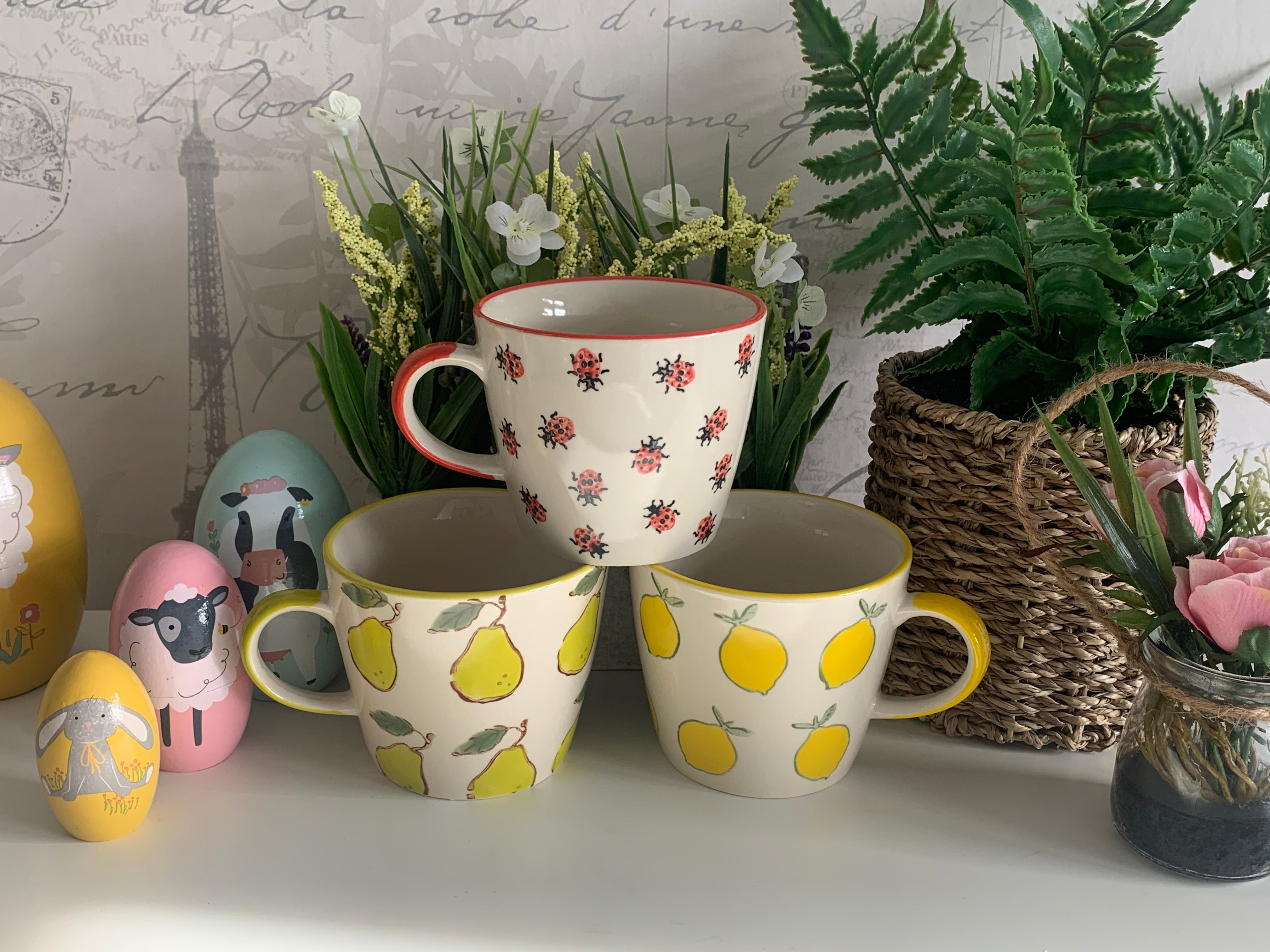 Shabbyquins ceramic mug with colorful floral design, perfect for coffee or tea, showcasing a stylish and functional mug.