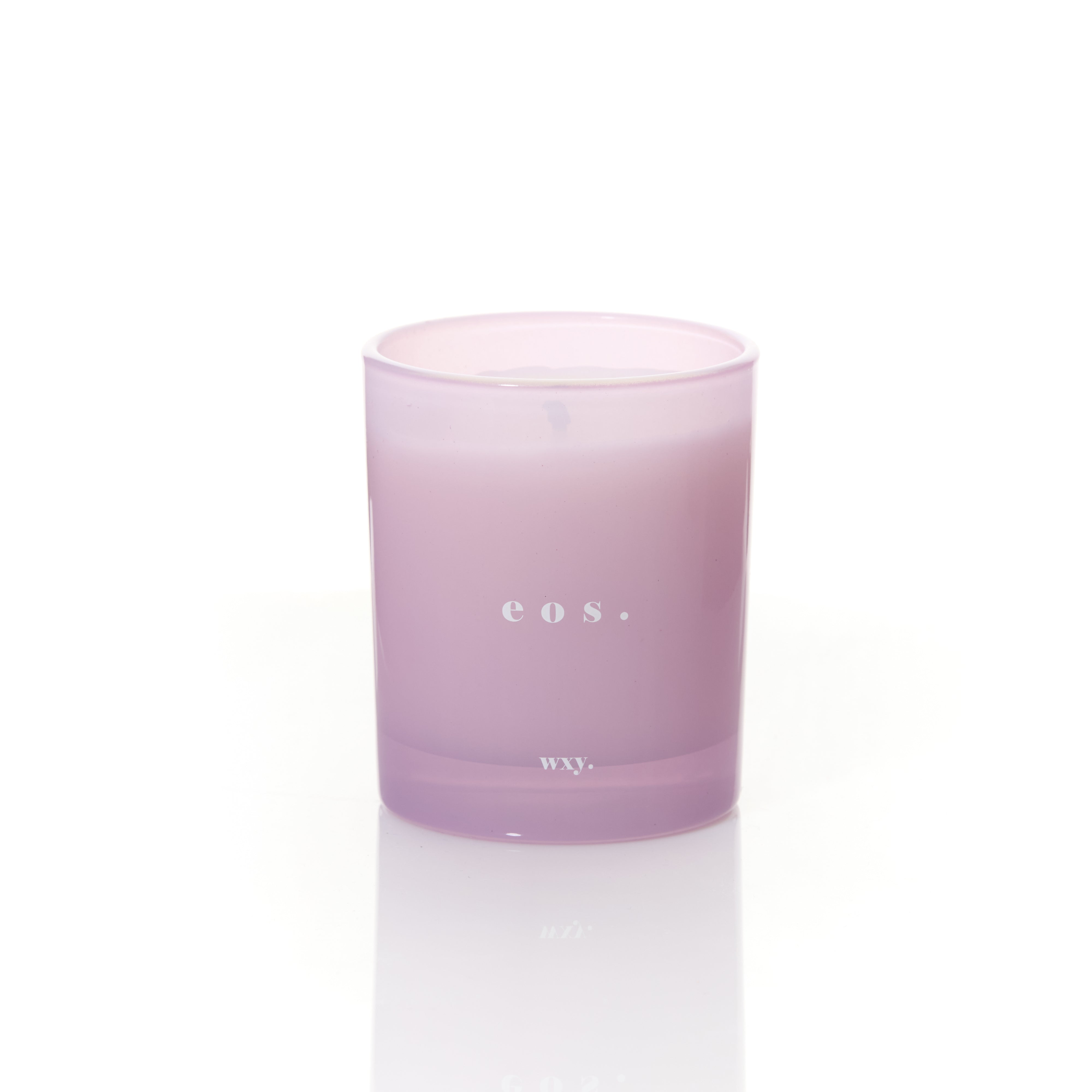 Sable Homeware Eos Orris Root & Amber Deluxe Candle in a glass jar with a lit wick and warm, inviting glow.