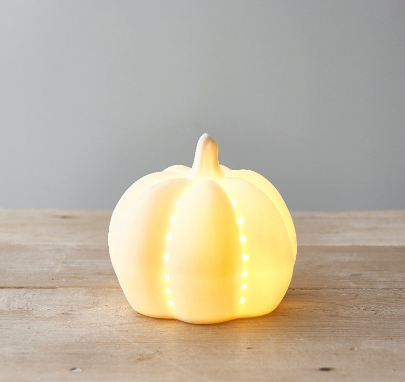 Ceramic LED Pumpkins Set of 2 by Sable Homeware — close up of warm amber LED glow through white ceramic pumpkin.