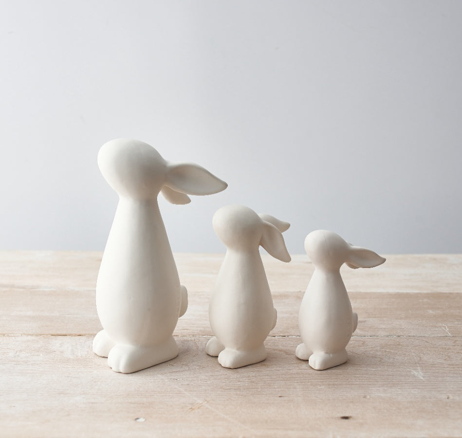 Set of 2 matte white Easter bunny ornaments with a smooth finish, ideal for seasonal holiday decor.