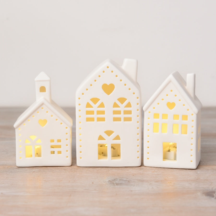 Shabbyquins LED Village with 3 charming China designs, featuring miniature buildings with warm lighting and detailed craftsmanship.