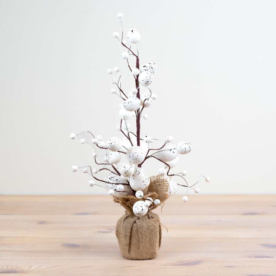 White artificial Easter egg tree by Shabbyquins featuring white eggs hanging on a decorative tree branch display.