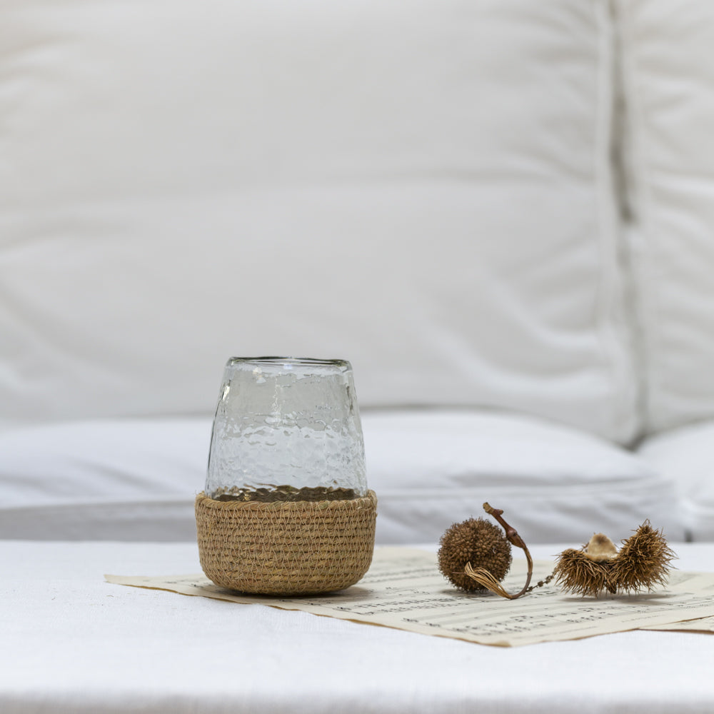 Hammered glass tea light candle holder in jute basket by Sable Homeware, with a rustic, textured design perfect for cozy decor.