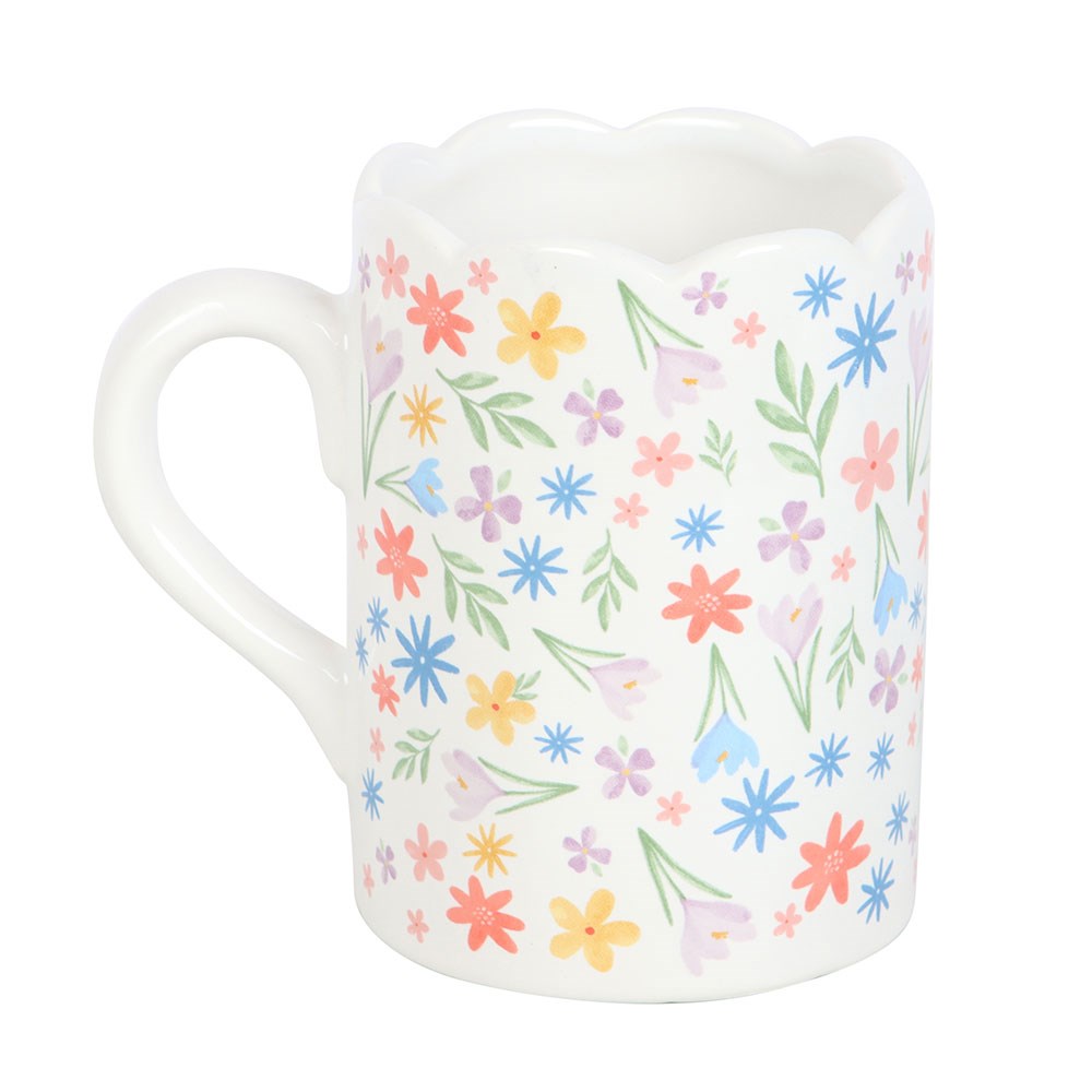 Floral print scalloped mug by Sable Homeware with a curved design and colorful floral pattern on white ceramic.