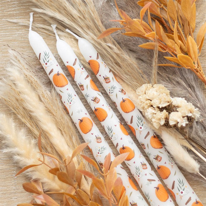Set of three pumpkin-shaped taper candles from Sable Homeware, featuring warm orange wax and elegant candle holders.