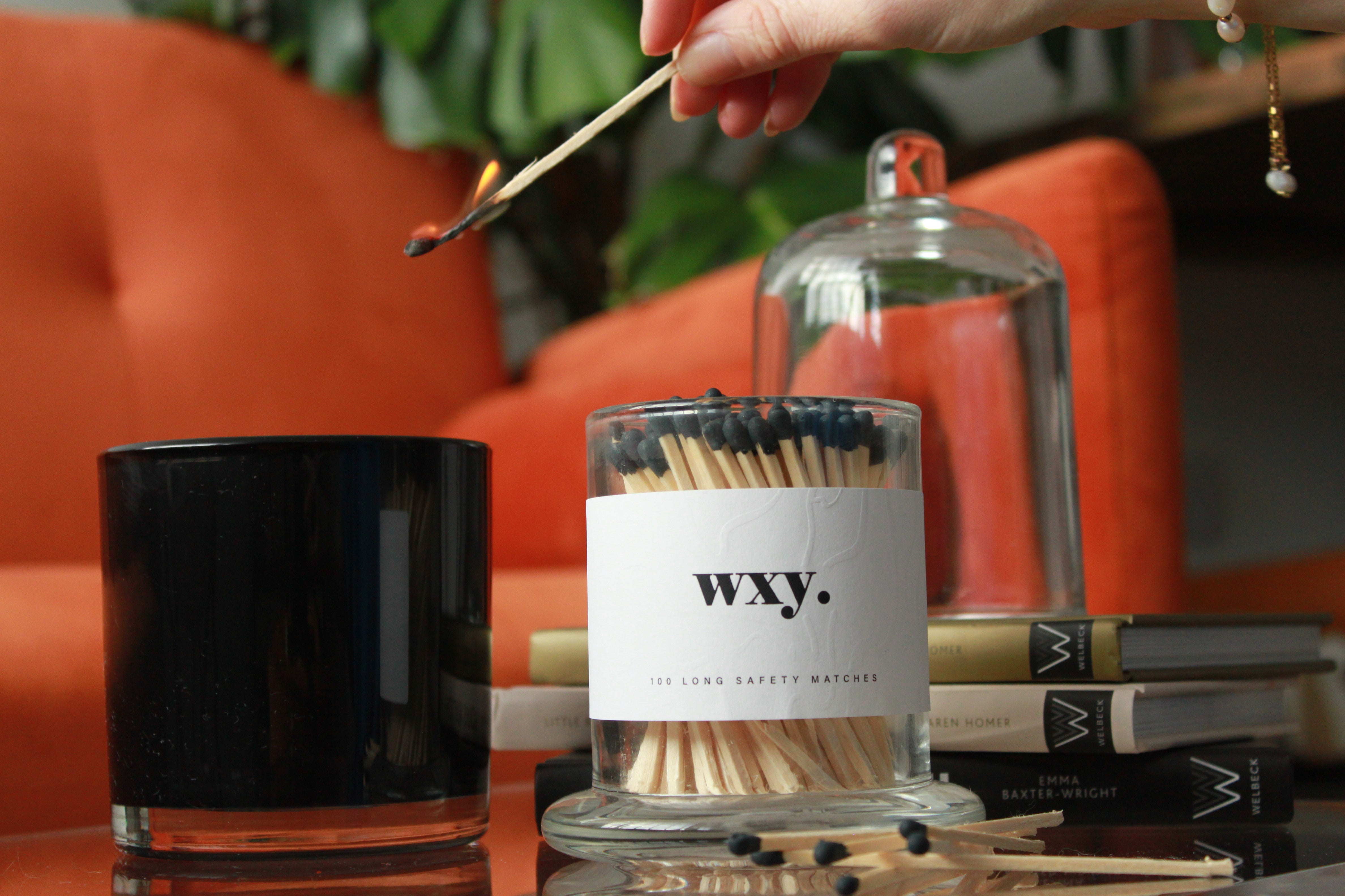 Sable Homeware Deluxe matches in a glass cloche display with wooden matches inside on a neutral surface.
