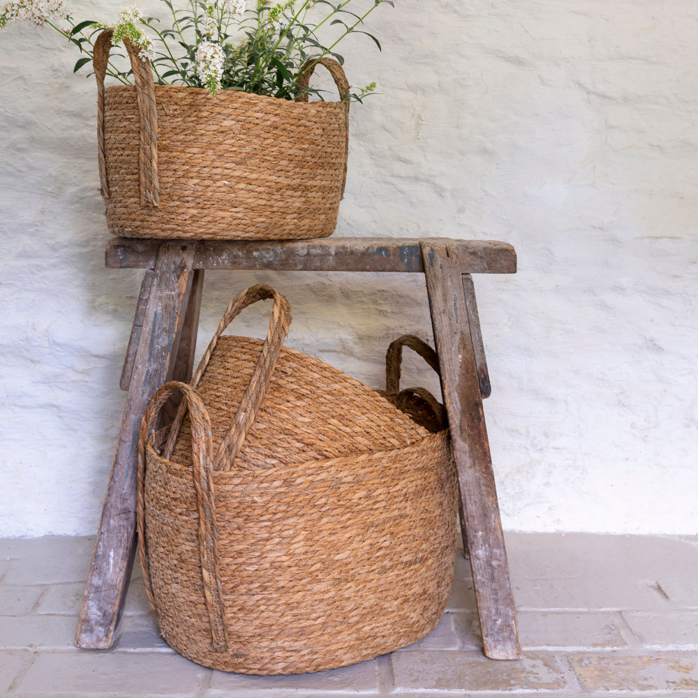 Set of three oval seagrass baskets with handles from Shabbyquins, natural woven storage baskets for home organization.