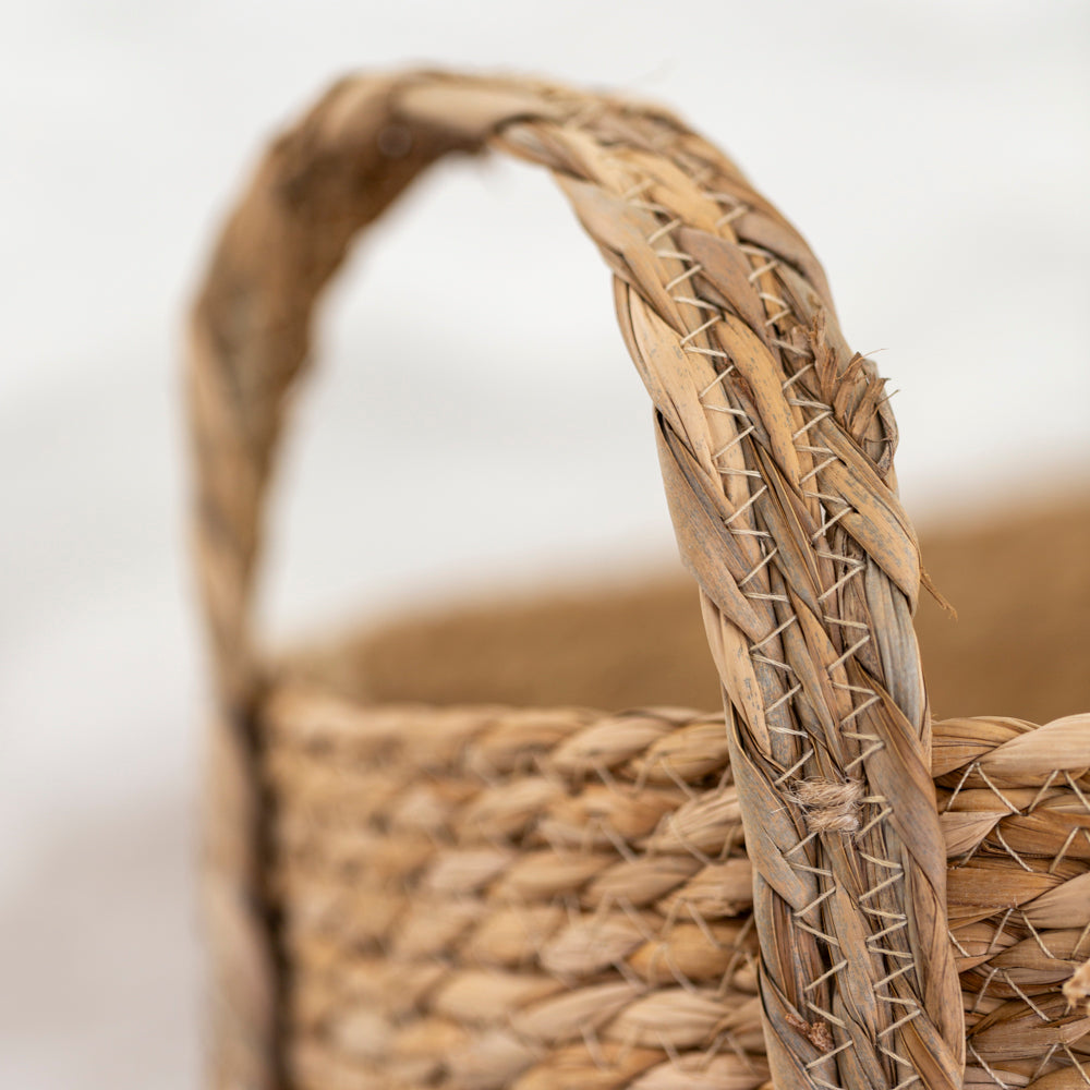 Set of three oval seagrass baskets with handles by Shabbyquins, natural woven baskets for storage and organization.