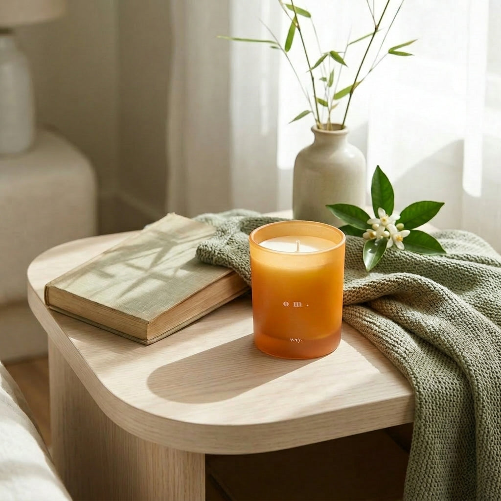 Sable Homeware Om Bamboo Leaf and Neroli Wxy Deluxe Candle in an elegant candle holder, creating a serene ambiance.