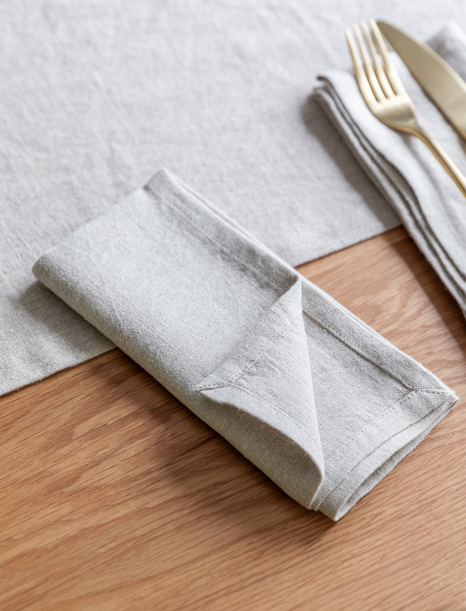 Set of four natural linen napkins from Sable Homeware Wittering Table Styling Set, featuring rattan and linen dining accessories.