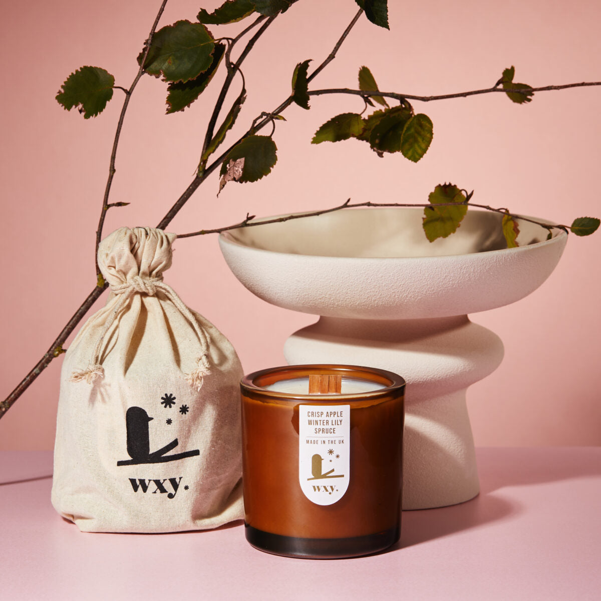 Sable Homeware luxury amber Christmas candle in a decorative candle holder, creating a festive holiday ambiance.