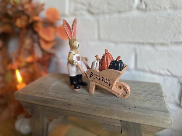 Shabbyquins Halloween rabbit ornament with a pumpkin-filled wheelbarrow, decorated for spooky seasonal display.