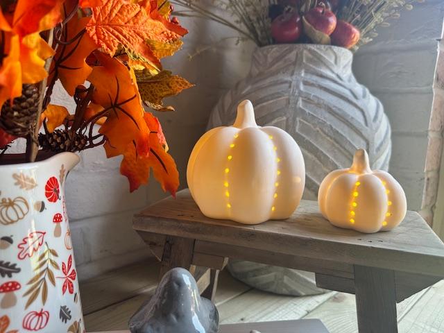 Set of two Shabbyquins ceramic Halloween LED pumpkins with glowing lights, perfect for festive fall decor.