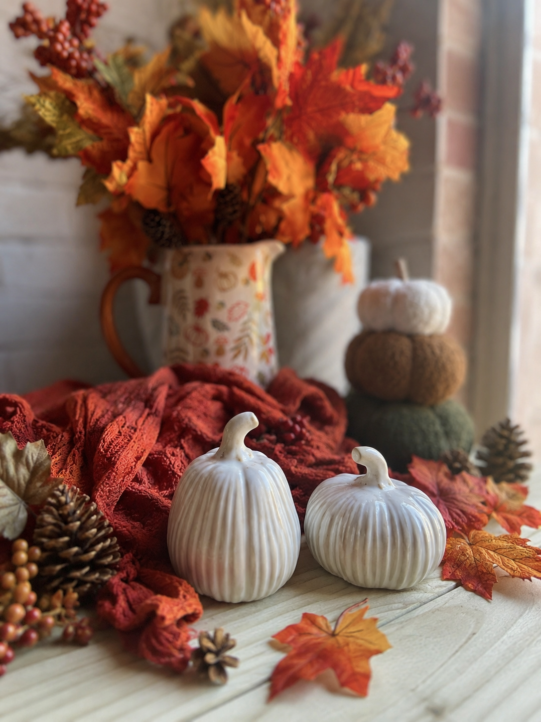 Reactive glazed pumpkin ornament by Sable Homeware with a glossy, textured surface showcasing warm autumn colors.