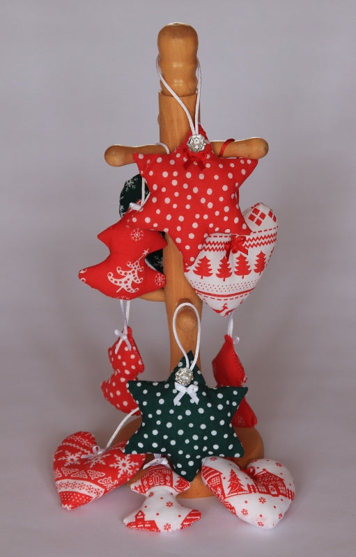 Handmade Christmas tree ornaments by Sable Homeware hanging on a decorated Christmas tree, featuring festive designs and holiday charm.